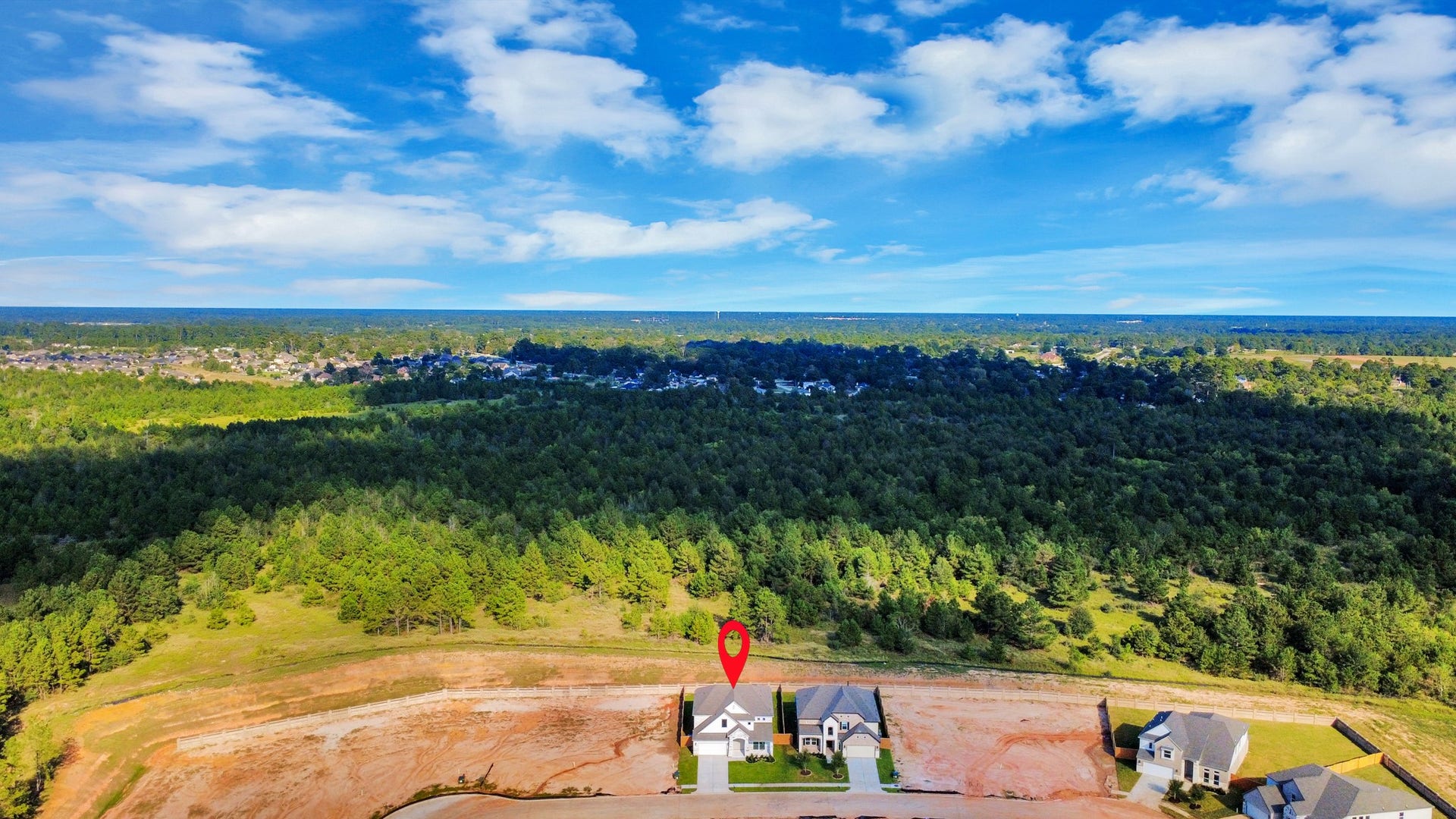 2097 Corn Thistle Way, Magnolia, TX 77355 An aerial view of a spacious subdivision lot, highlighting a well-maintained yard and a fully fenced perimeter, offering both privacy and expansive outdoor space.