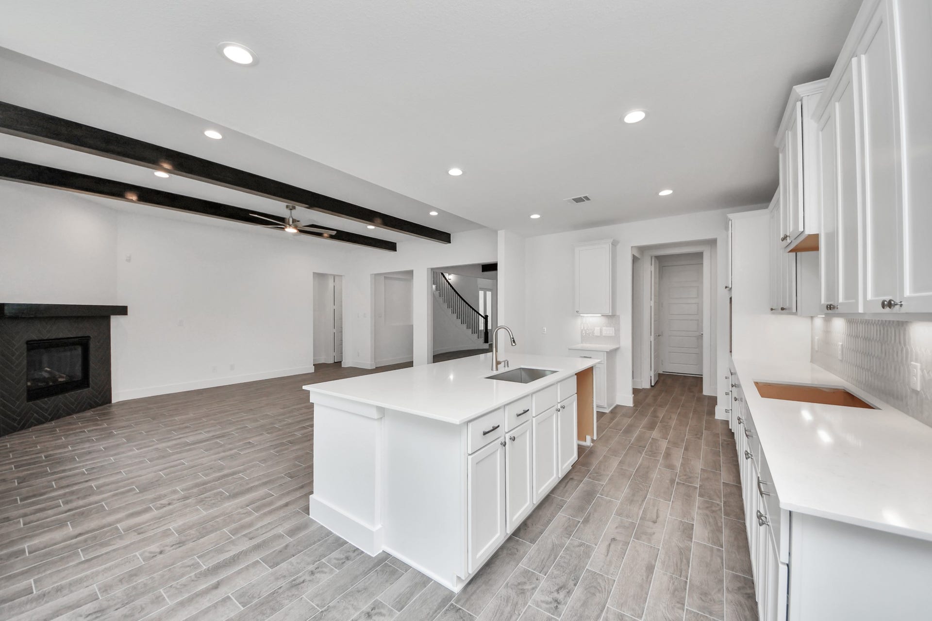 2097 Corn Thistle Way, Magnolia, TX 77355 The open concept effortlessly connects the kitchen to the expansive family room, forming a perfect hub for gatherings. This seamless flow creates an inviting space where cooking and socializing come together harmoniously.