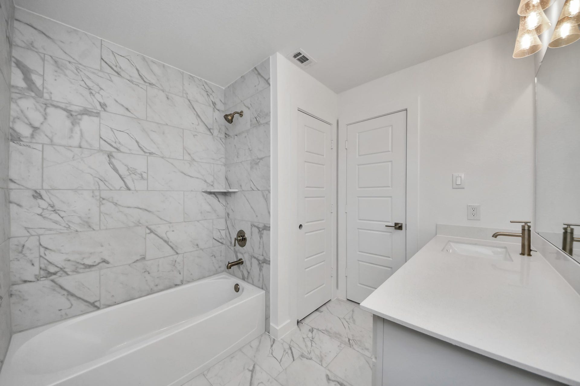2097 Corn Thistle Way, Magnolia, TX 77355 Secondary bath features tile flooring, bath/shower combo with tile surround, light stained wood cabinets, beautiful light countertop.