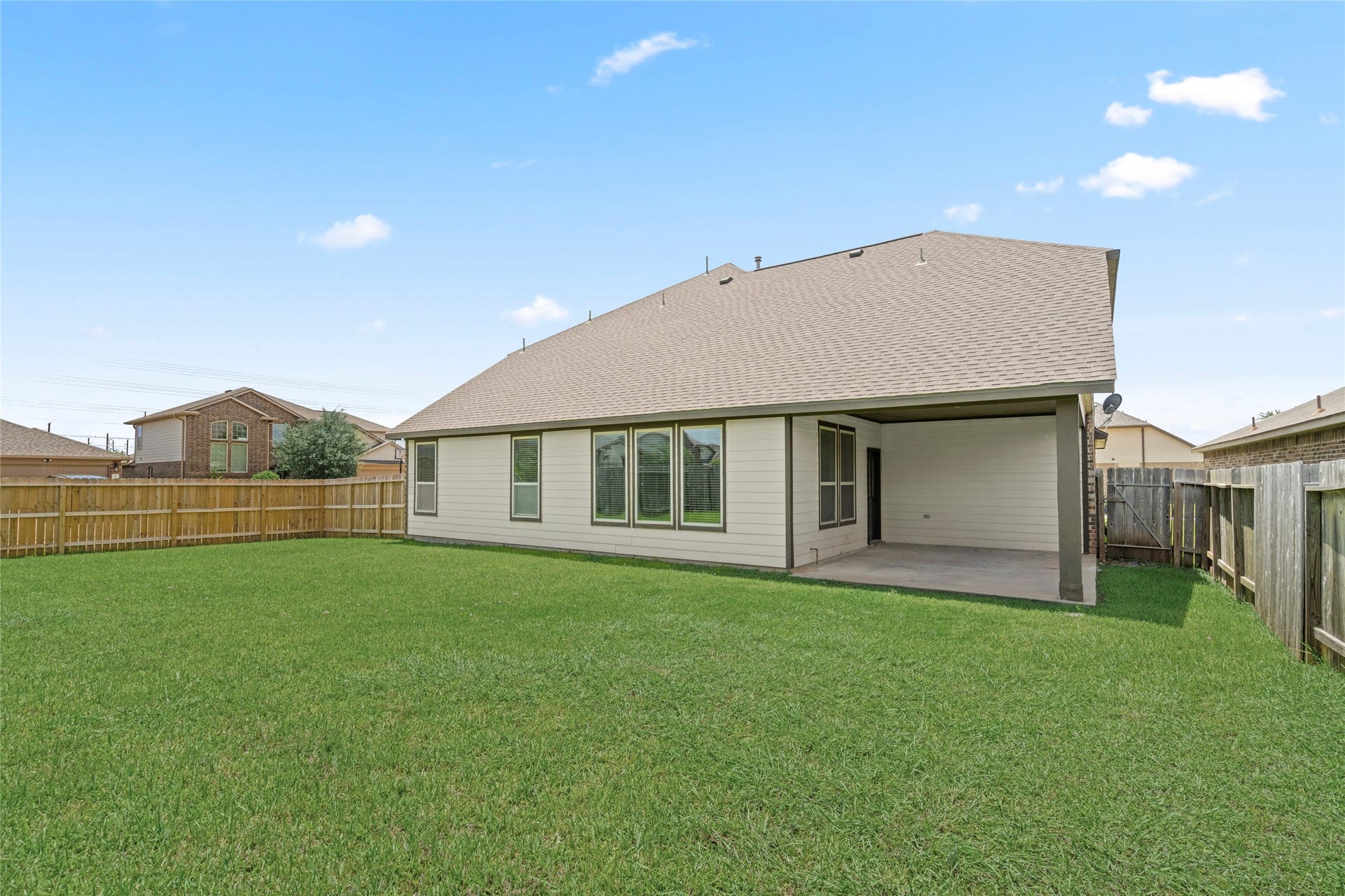 9423 Mineral Rock Lane, Richmond, TX 77407 Expansive backyard perfect for outdoor gatherings, complete with a covered patio for relaxation and entertaining.