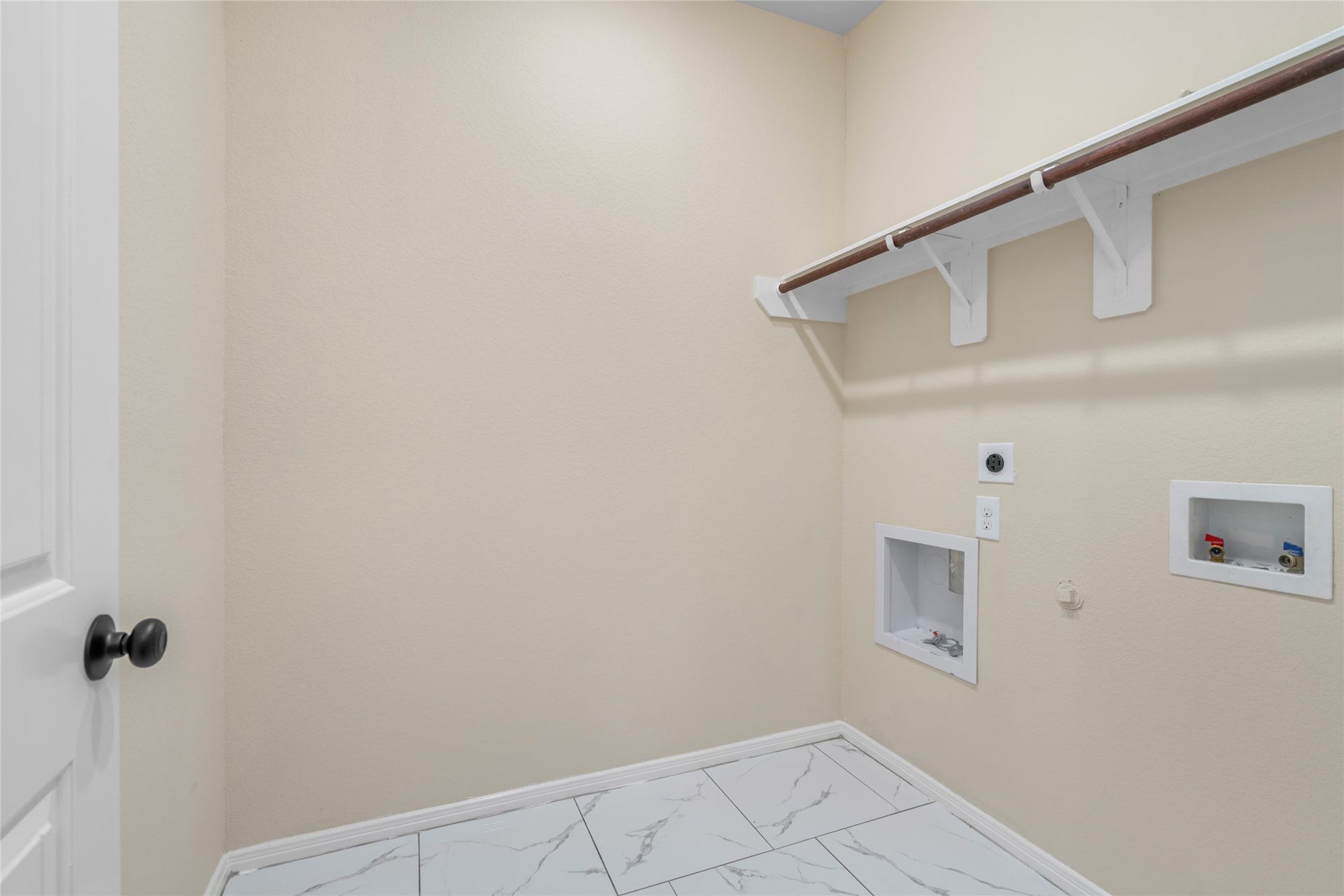 9423 Mineral Rock Lane, Richmond, TX 77407 Spacious walk-in closet with sleek tile flooring and ample shelving, offering a perfect blend of style and functionality.