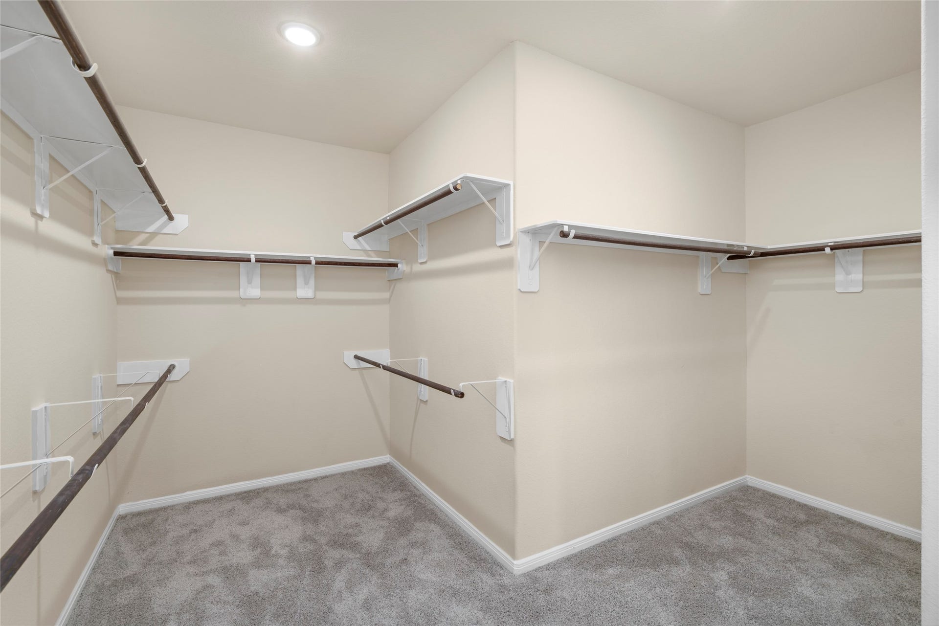 9423 Mineral Rock Lane, Richmond, TX 77407 Step into luxury with this expansive walk-in closet, offering ample space to organize and display your wardrobe in style.