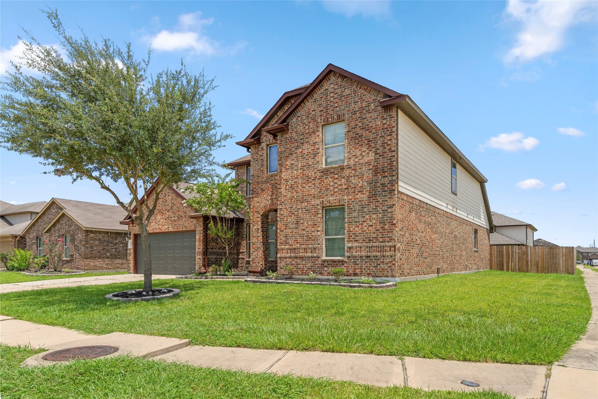 9423 Mineral Rock Lane, Richmond, TX 77407 Wide, well-kept front lawn and mature landscaping create an inviting first impression from the street.