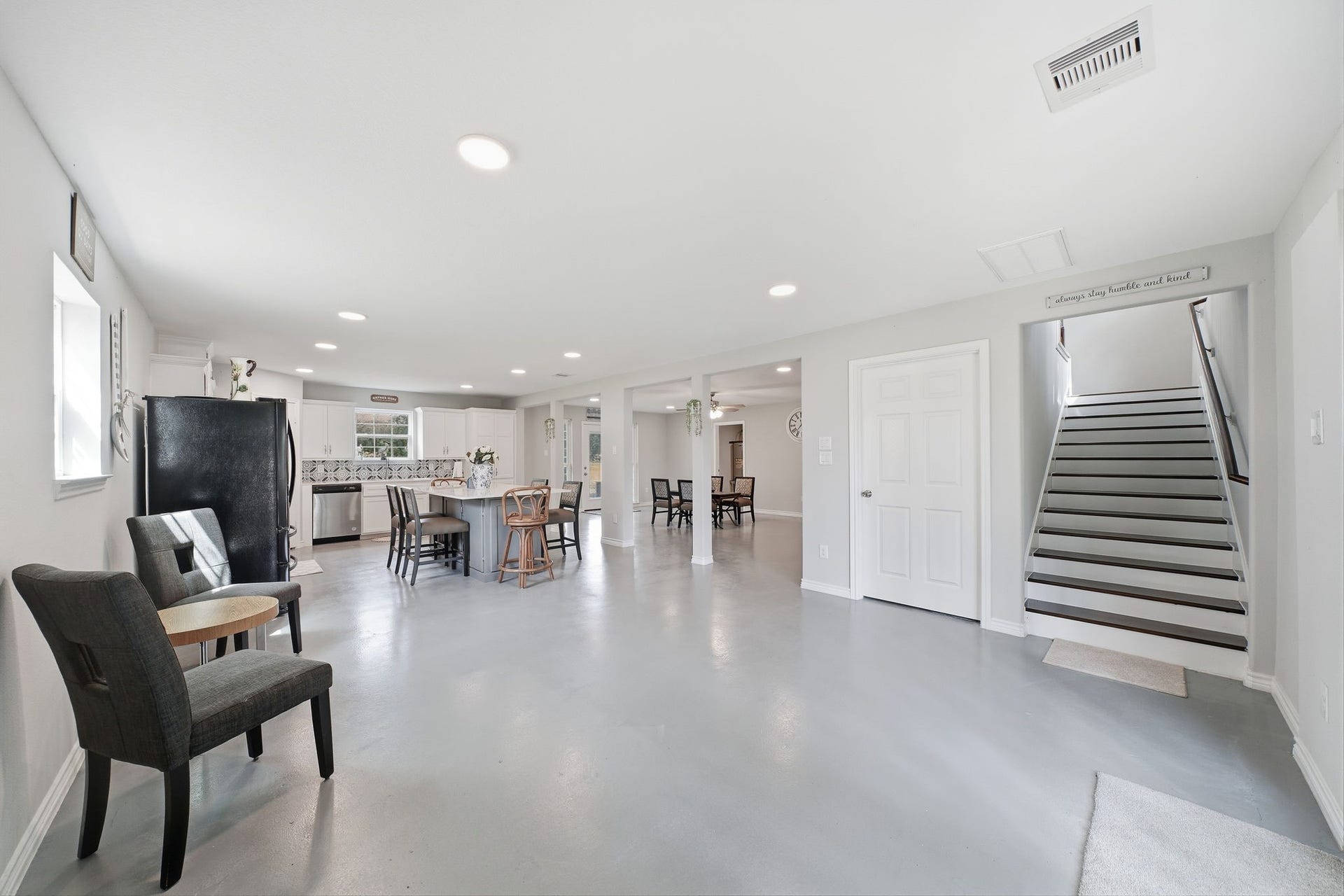 450 N Sunset Boulevard, Holiday Lakes, TX 77515 The kitchen features a large breakfast area facing the staircase and opening to French double doors to the backyard, creating a warm, airy feel.