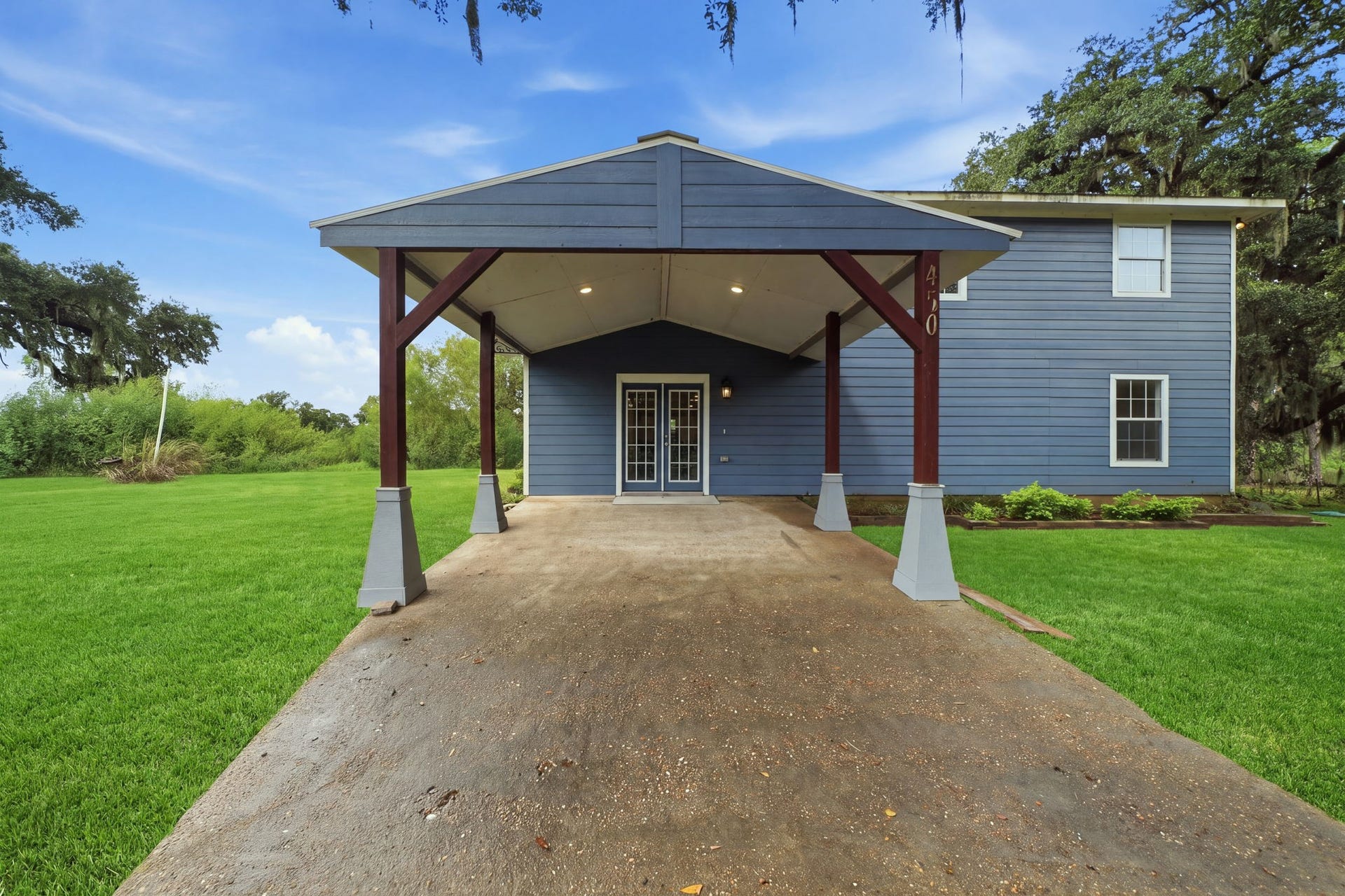 450 N Sunset Boulevard, Holiday Lakes, TX 77515 A covered carport at the front of the home comfortably fits two cars and gives you direct, sheltered access to the house.