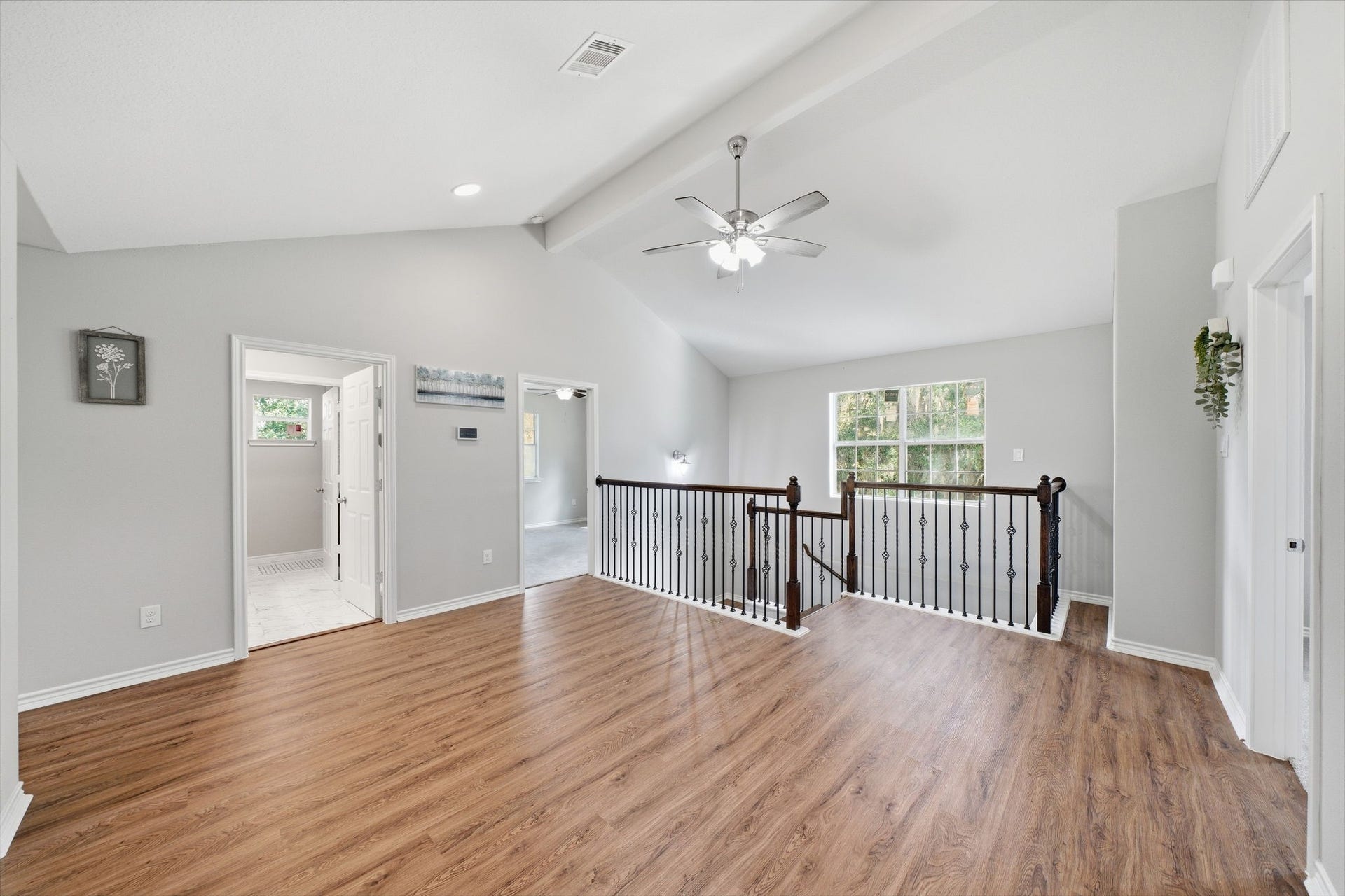 450 N Sunset Boulevard, Holiday Lakes, TX 77515 Upstairs Hallway: Light-filled and open, with bedrooms and a bath close together and an open railing overlooking the stairs.