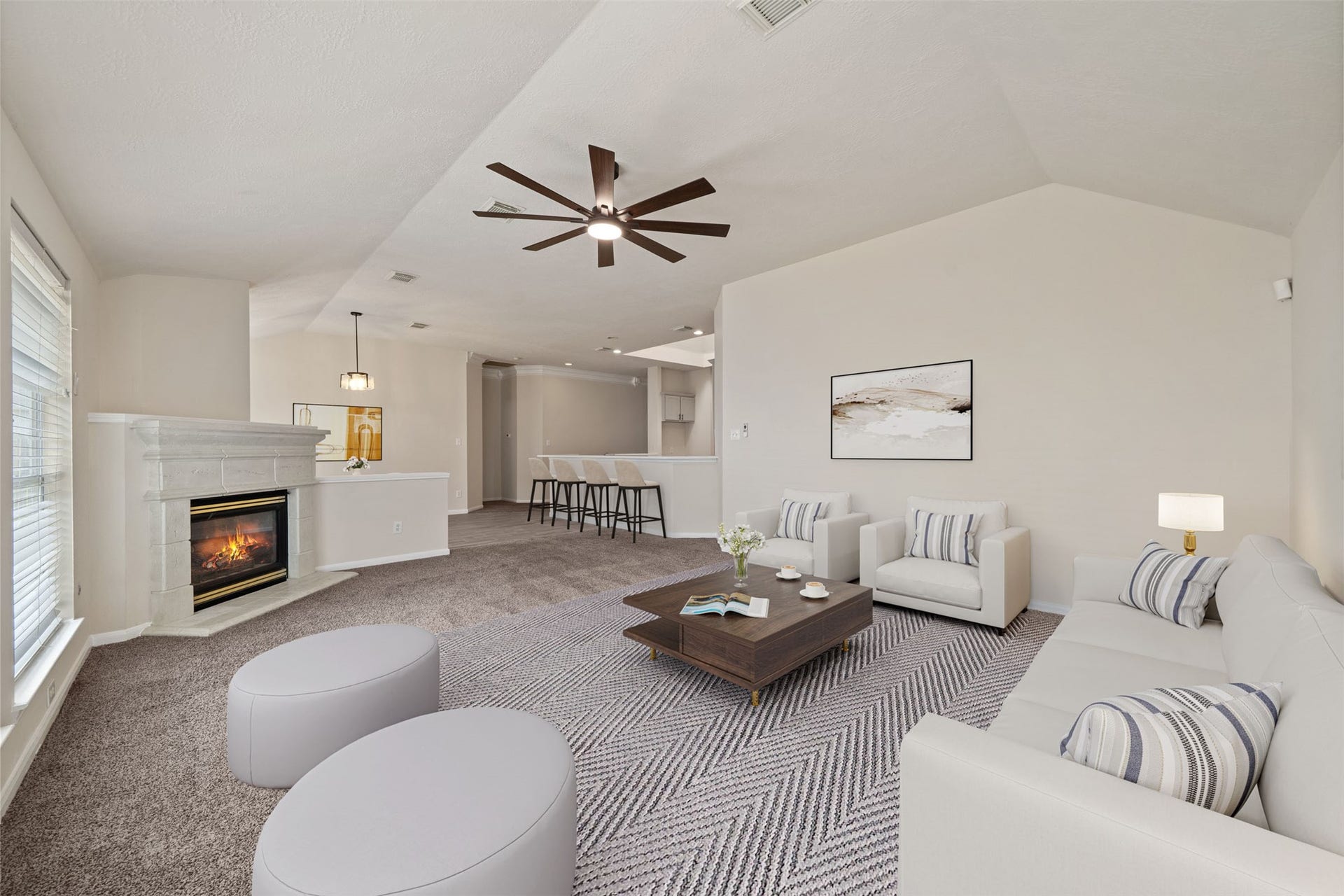 10902 Trail Ridge Drive, Houston, TX 77064 Spacious and inviting den features a stone gas fireplace, modern ceiling fan, and seamless transition to an open dining space, perfect for entertaining. *virtually staged
