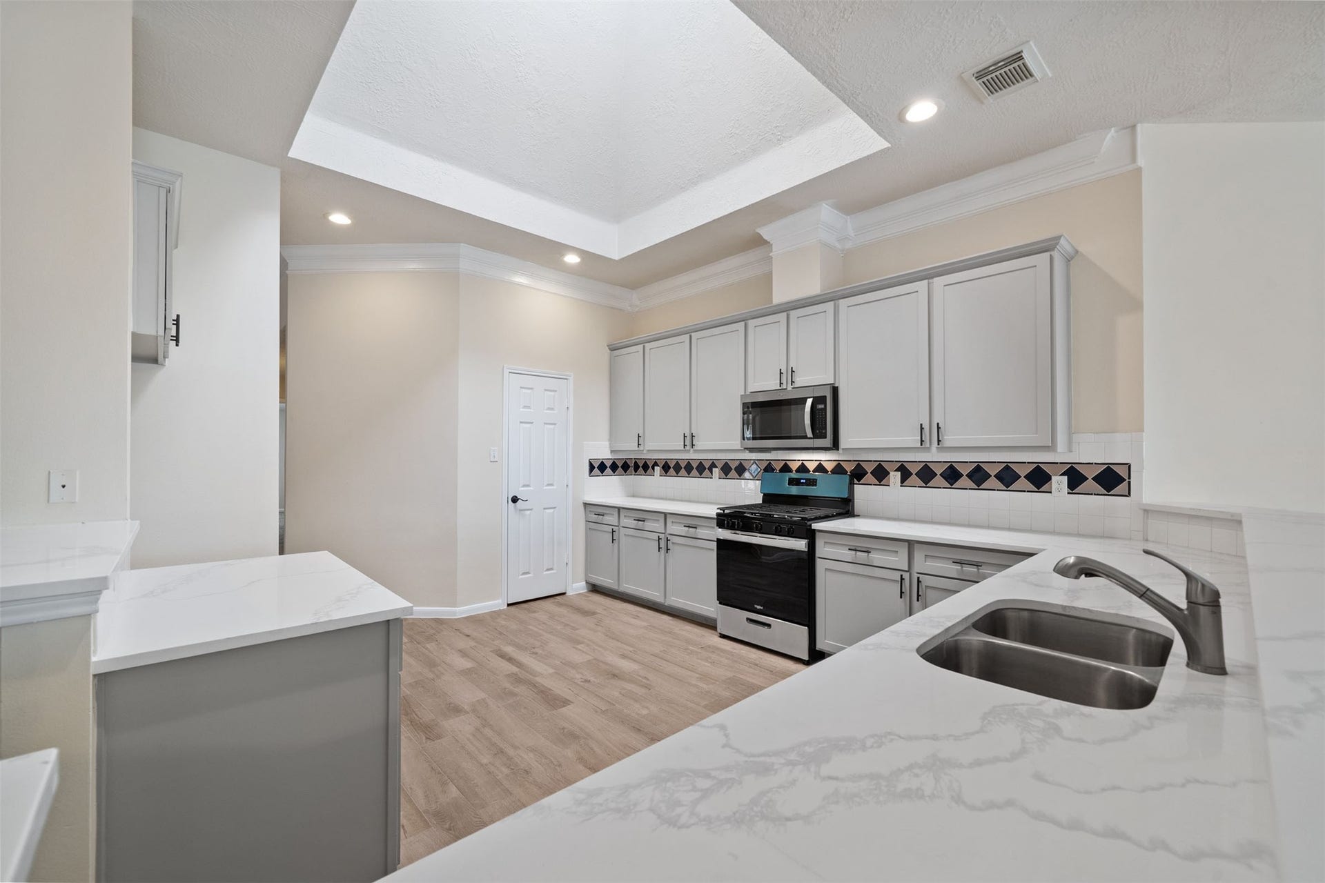 10902 Trail Ridge Drive, Houston, TX 77064 Elegant kitchen space with crown molding and ample lighting, perfect for culinary enthusiasts.