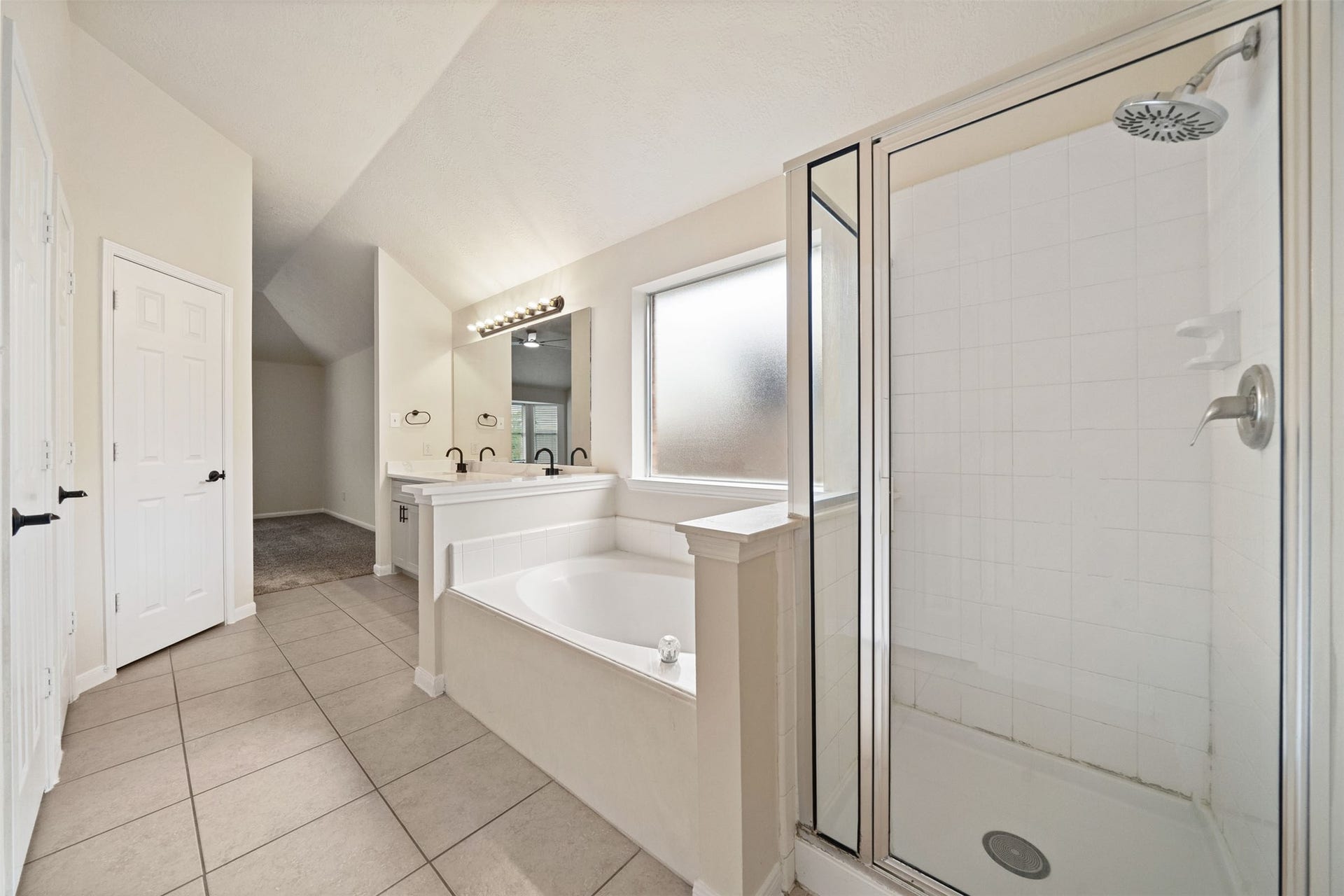 10902 Trail Ridge Drive, Houston, TX 77064 Featuring a luxurious soaking tub and separate glass-enclosed shower