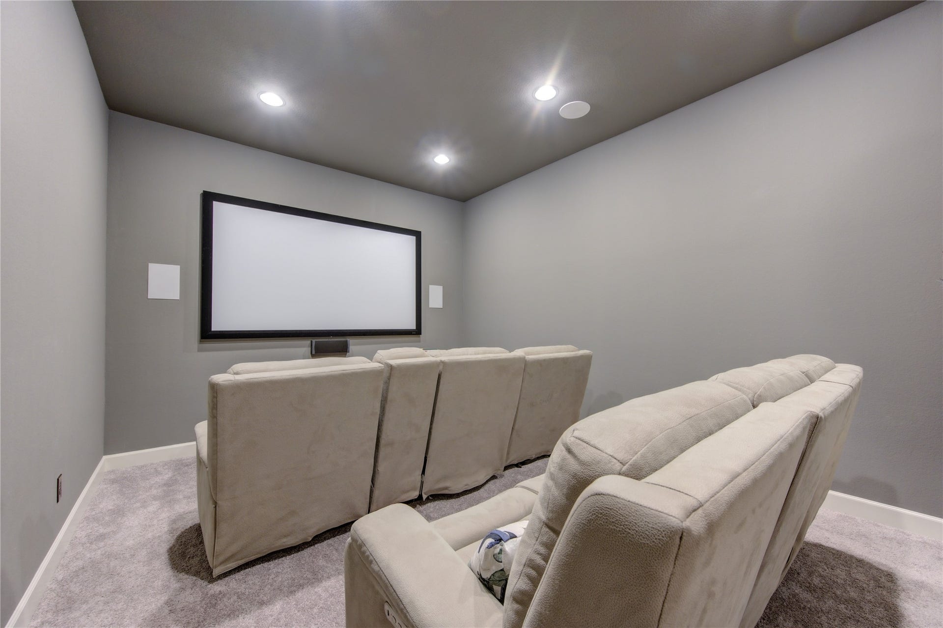 Home Theater Experience: Enjoy movie nights in this dedicated media room, complete with built-in surround sound wiring, soft carpeting, and dimmable lighting. This versatile space, on one level in this home, can easily be a game room for the kids as well.