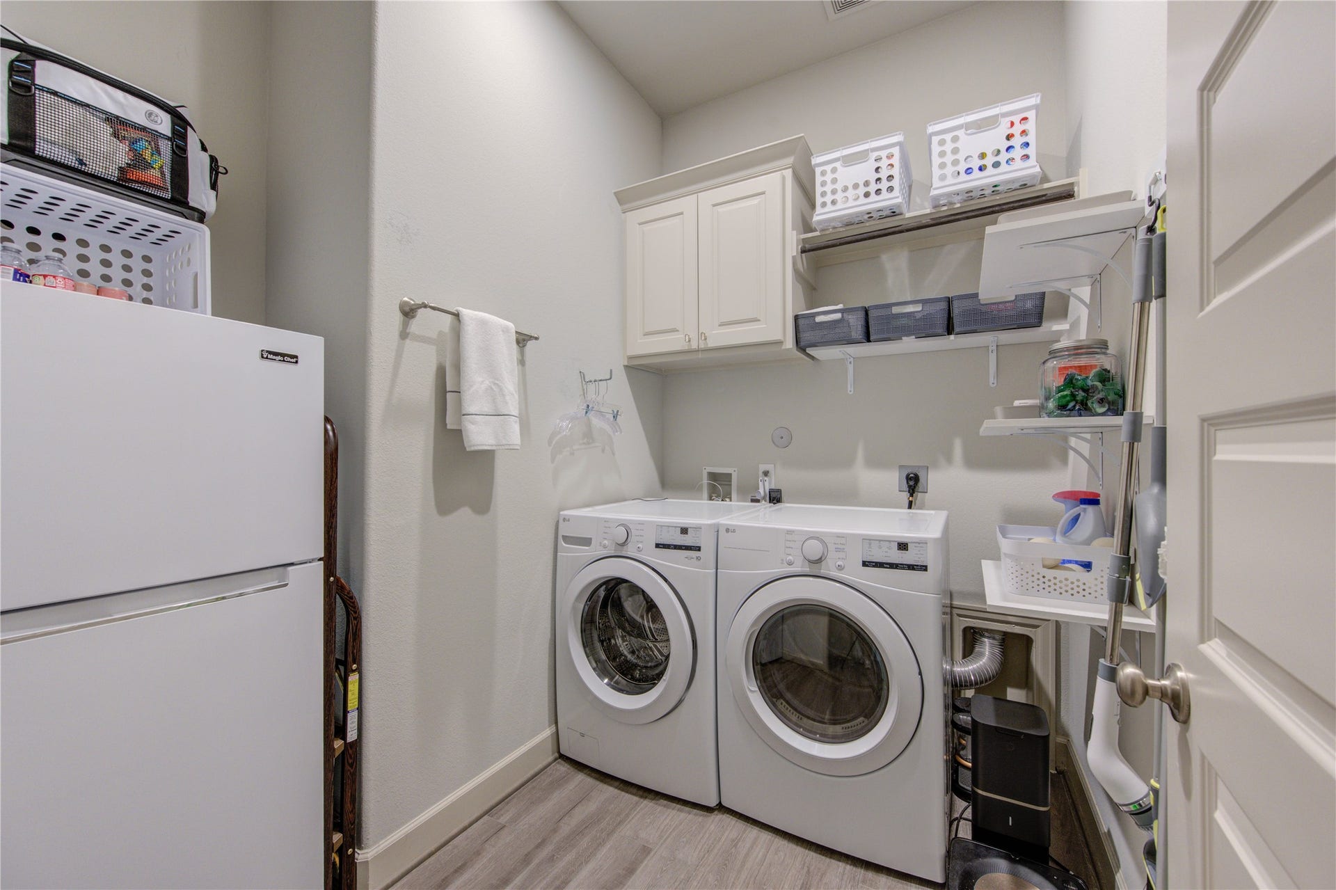 Located just off the kitchen, this large laundry room offers both functionality and extra storage space. Designed for efficiency, it includes ample room for a washer and dryer, along with additional cabinetry for organization.