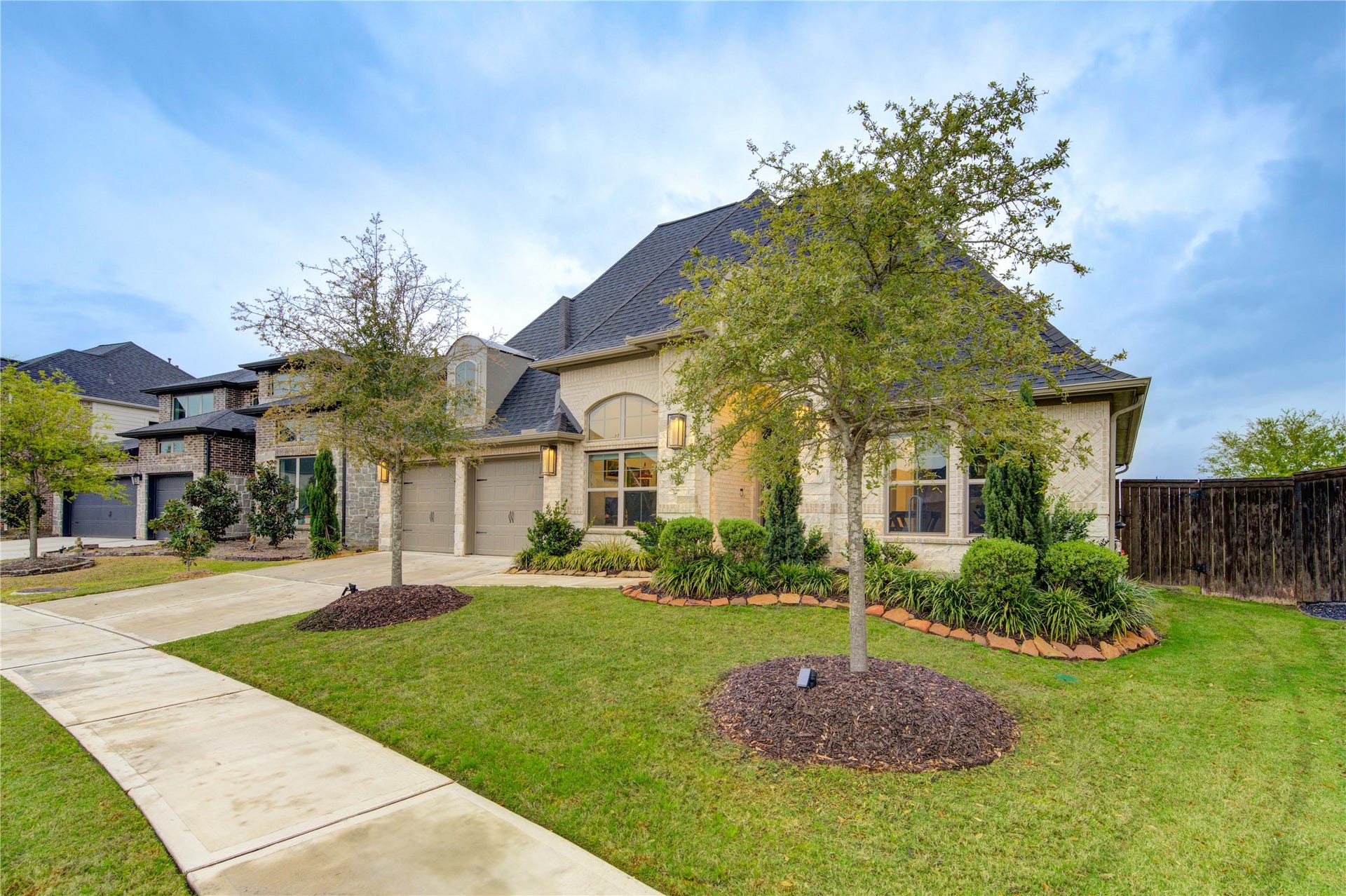 The combination of gracious architecture, a sprawling side yard, and a three-car garage makes this property exceptionally inviting.