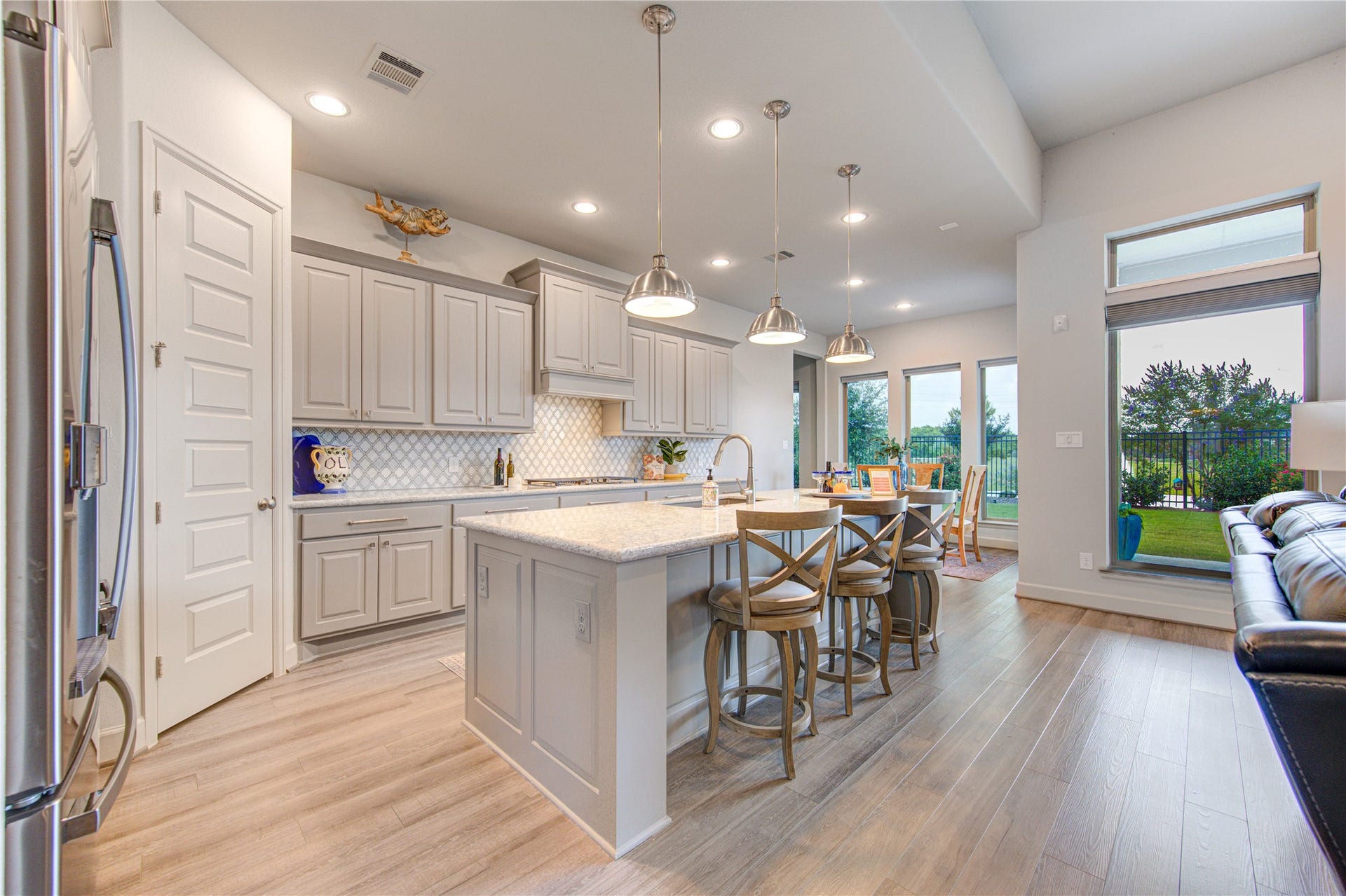 Gourmet Kitchen with a View: Designed for both beauty and functionality, the kitchen features sleek Quartz countertops, custom cabinetry, a large island with bar seating, and stainless steel appliances. Enjoy lake views as you cook and entertain.