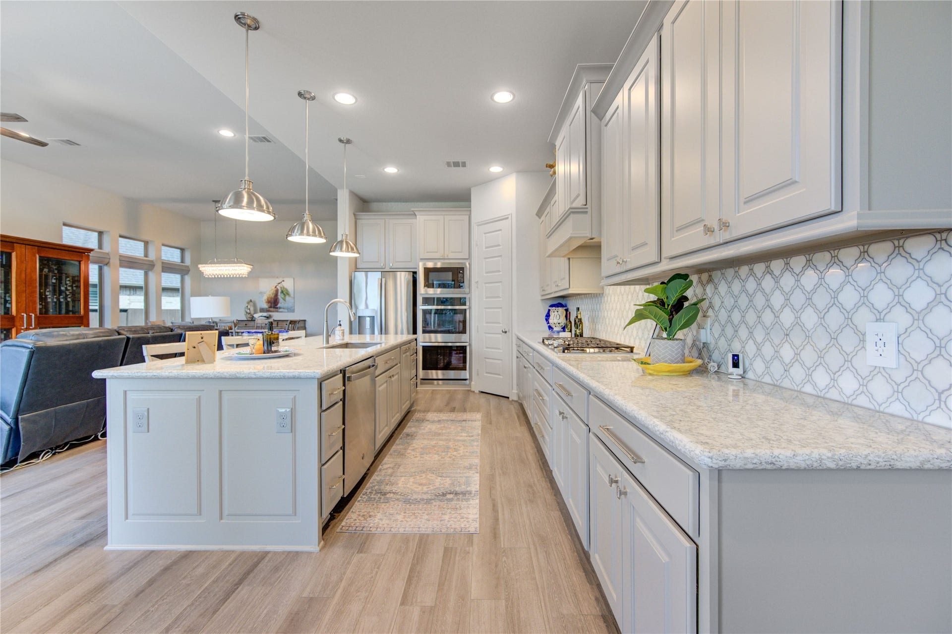 The kitchen seamlessly flows into the breakfast nook and living area, creating an inviting open-concept space ideal for gatherings. Whether you're hosting a dinner party or enjoying a quiet morning coffee with a view, this kitchen is the perfect blend of style and efficiency.