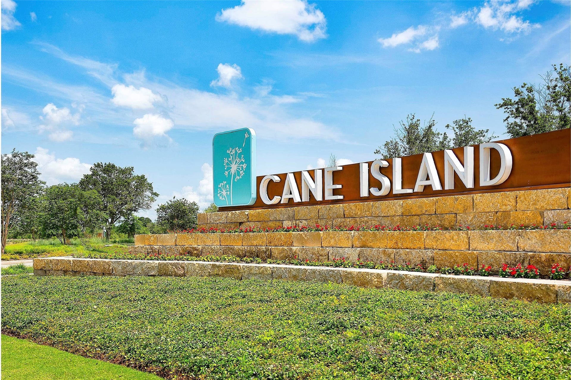 The Cane Island community entrance features a grand, stone-clad entry gate with elegant architectural details, making a statement as you drive into this prestigious neighborhood.