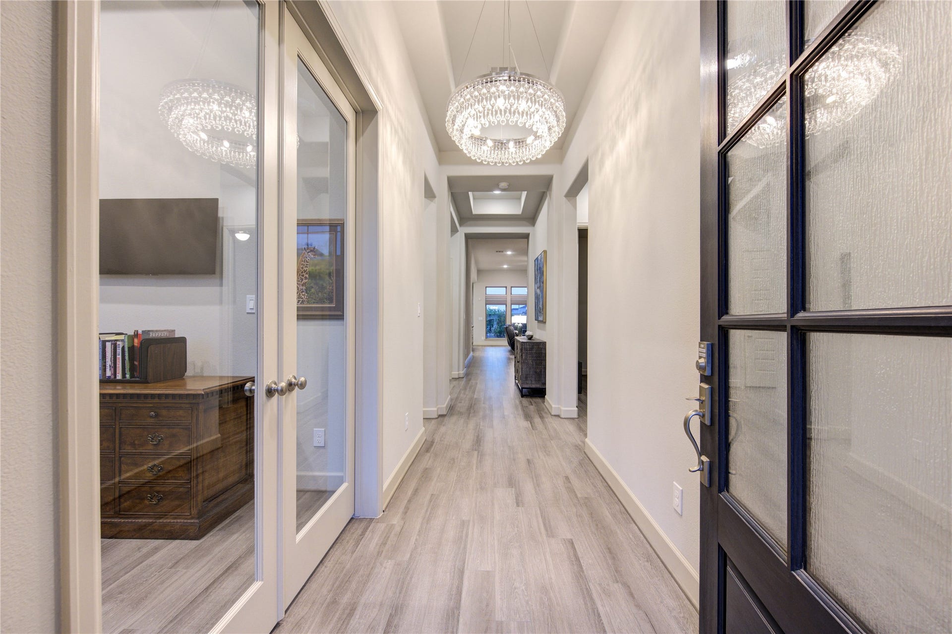 Step inside to soaring ceilings and an abundance of natural light. The elegant Luxury Vinyl Flooring leads seamlessly into the main living spaces.