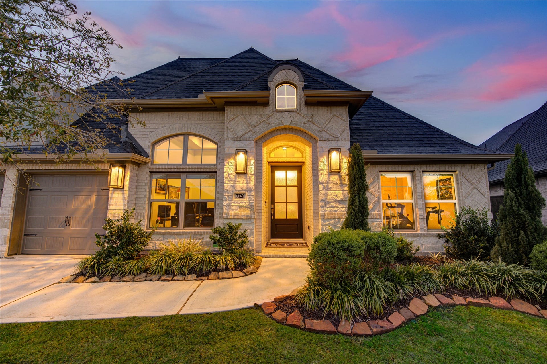 Large windows and a charming covered front porch complete the inviting exterior, making this home stand out in the neighborhood. It offers a perfect balance of traditional charm and modern appeal, all set against a backdrop of peaceful surroundings.