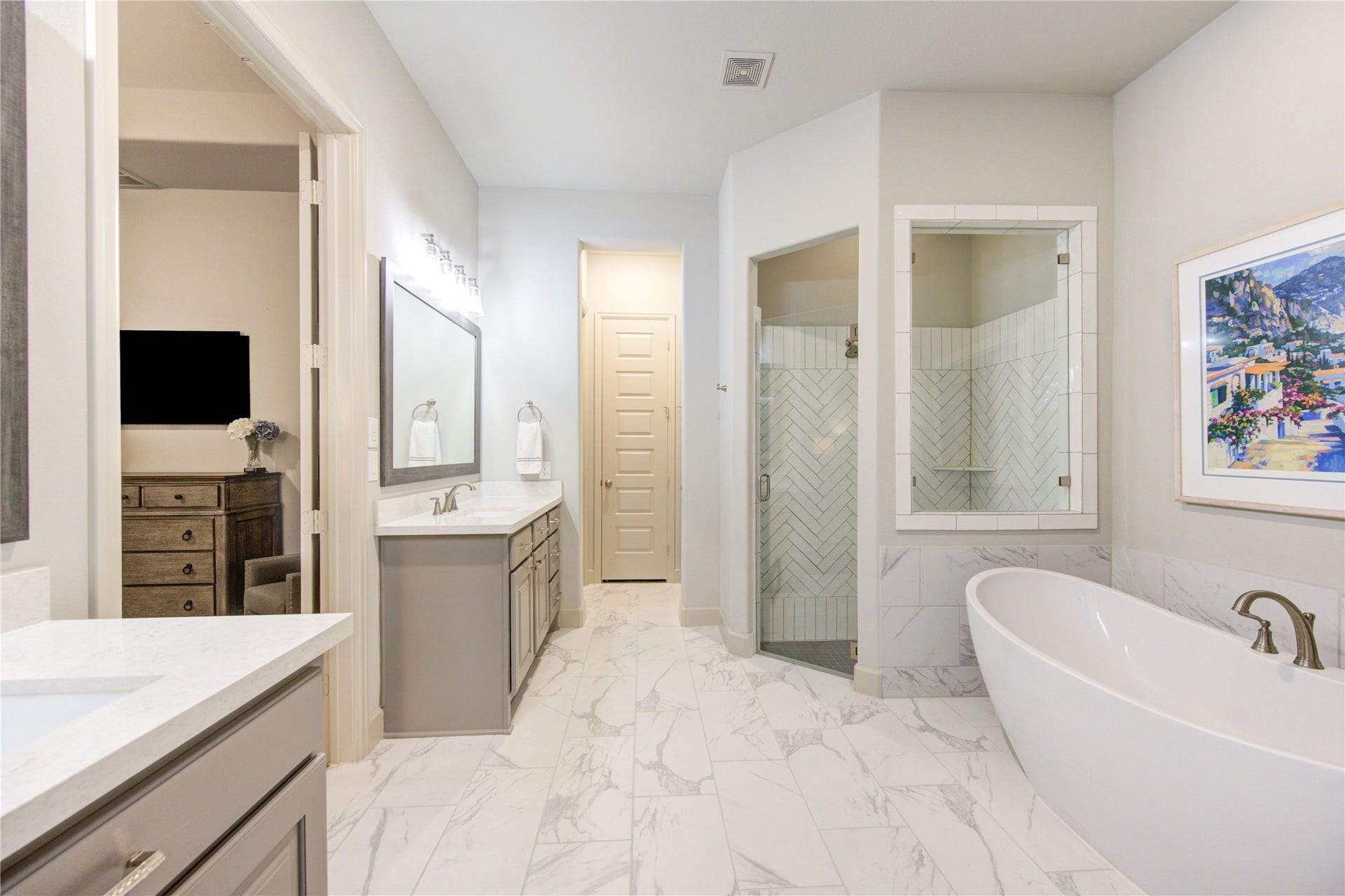 Primary Bathroom: The spa-like en-suite bathroom boasts dual vanities with granite countertops, a soaking tub, a separate walk-in shower with a frameless glass door, and a generous walk-in closet.