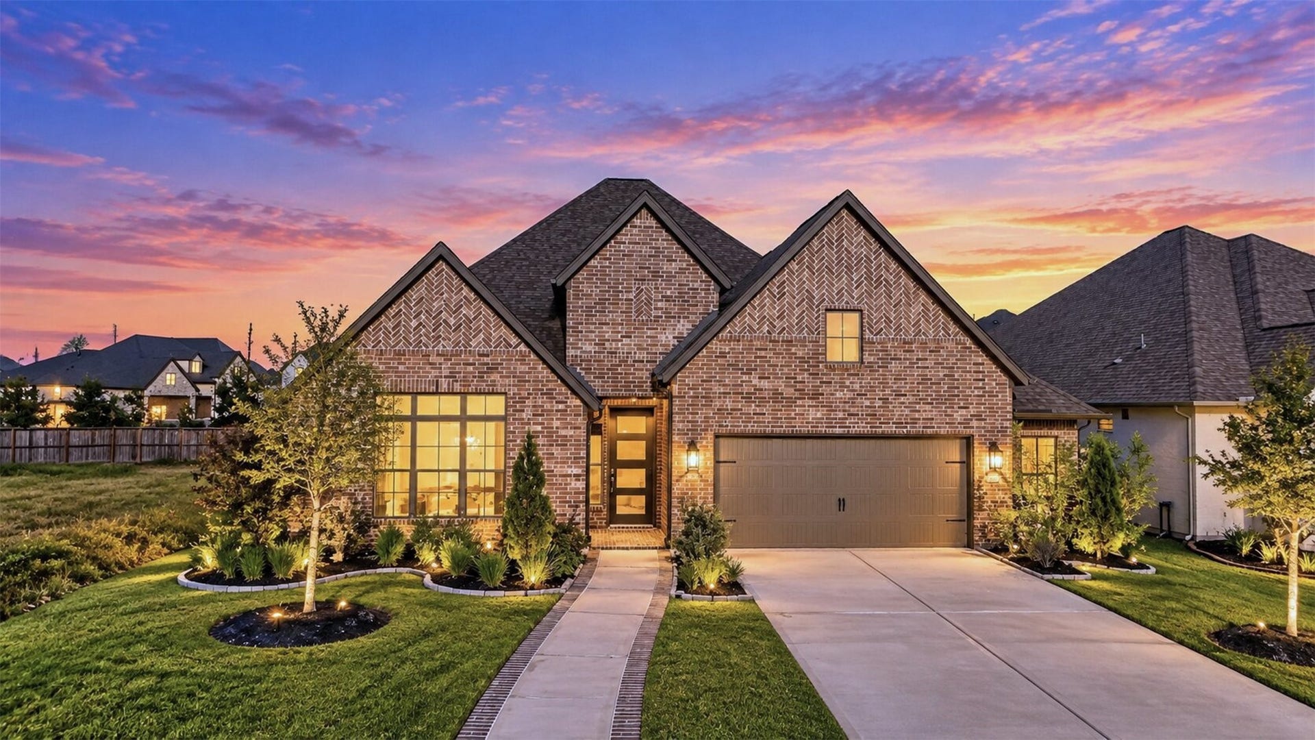 16270 Blue Mistflower Lane, Hockley, TX 77447 Front Exterior Twilight: Beautiful brick exterior with distinctive architectural detailing, manicured landscaping, and warm exterior lighting that showcases the home's curb appeal.