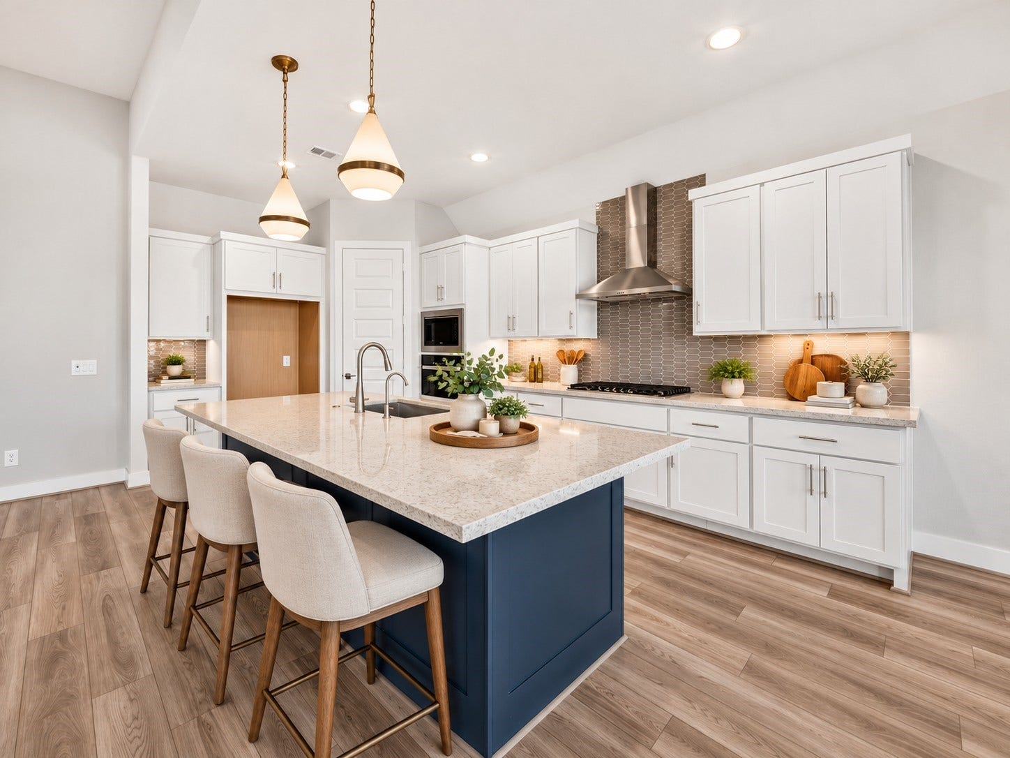 16270 Blue Mistflower Lane, Hockley, TX 77447 Gourmet Kitchen & Oversized Island: Stunning kitchen featuring an expansive navy island with seating, elegant pendant lighting, gas cooktop, abundant cabinetry, and beautiful contrasting finishesdesigned for effortless entertaining.