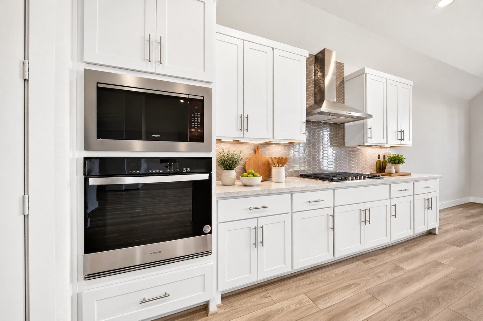 16270 Blue Mistflower Lane, Hockley, TX 77447 Gourmet Kitchen: Sophisticated kitchen showcasing built-in stainless steel appliances, elegant white cabinetry, under-cabinet lighting, decorative tile backsplash, and sleek countertops.