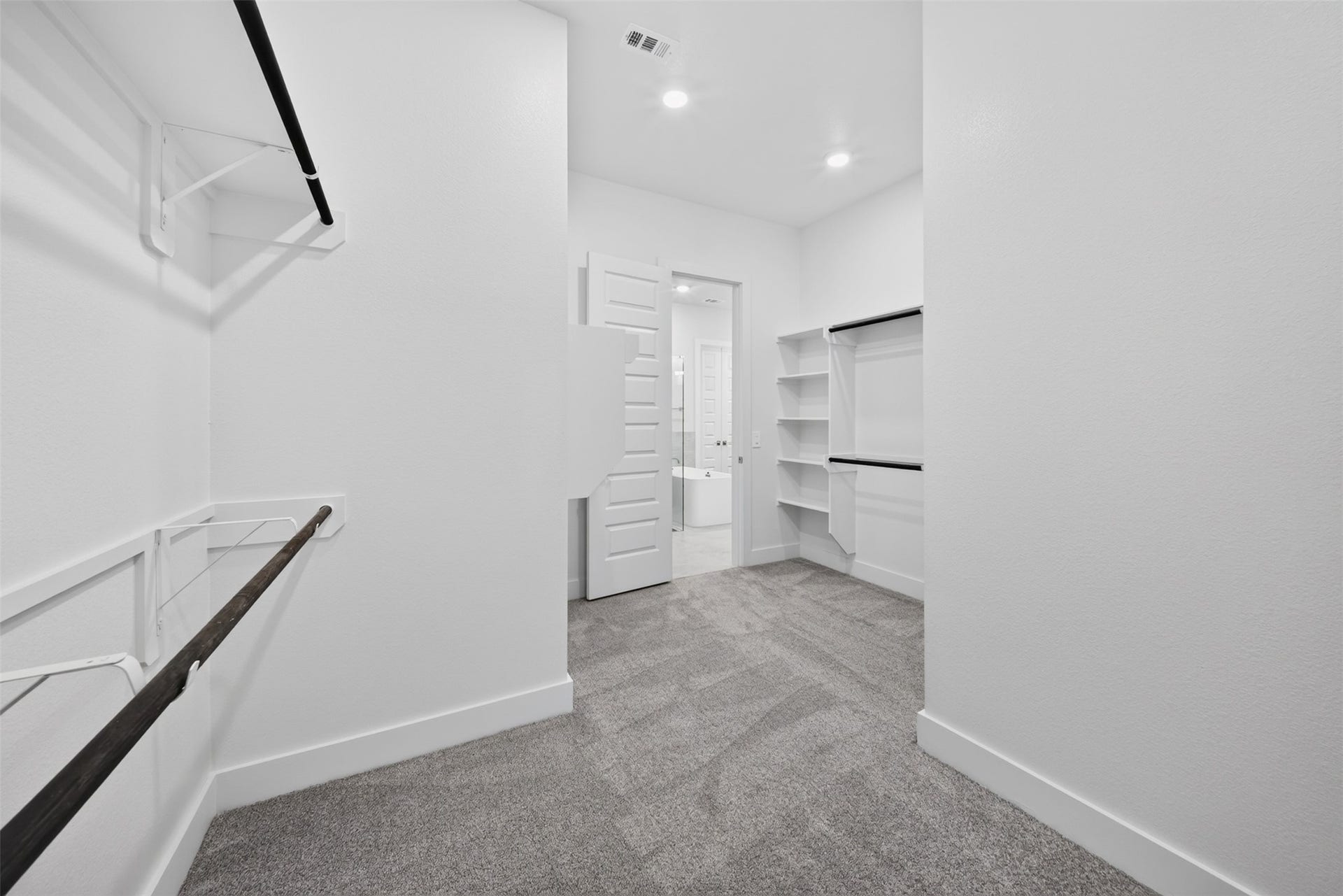 16270 Blue Mistflower Lane, Hockley, TX 77447 Primary Walk-In Closet: Generously sized primary closet featuring multiple hanging areas, shelving, and an expansive layout for everyday organization.