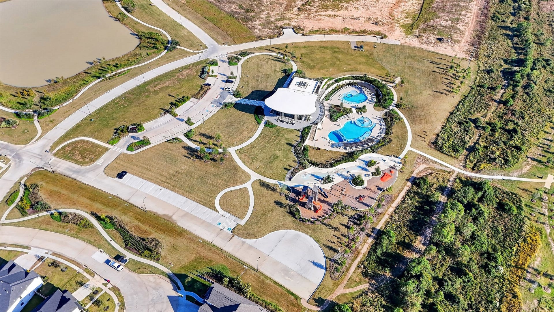 16270 Blue Mistflower Lane, Hockley, TX 77447 The Grand Prairie Aerial Community View: Discover exceptional community amenities featuring resort-style pools, a beautiful clubhouse, playgrounds, and scenic walking trails surrounded by landscaped green spaces.