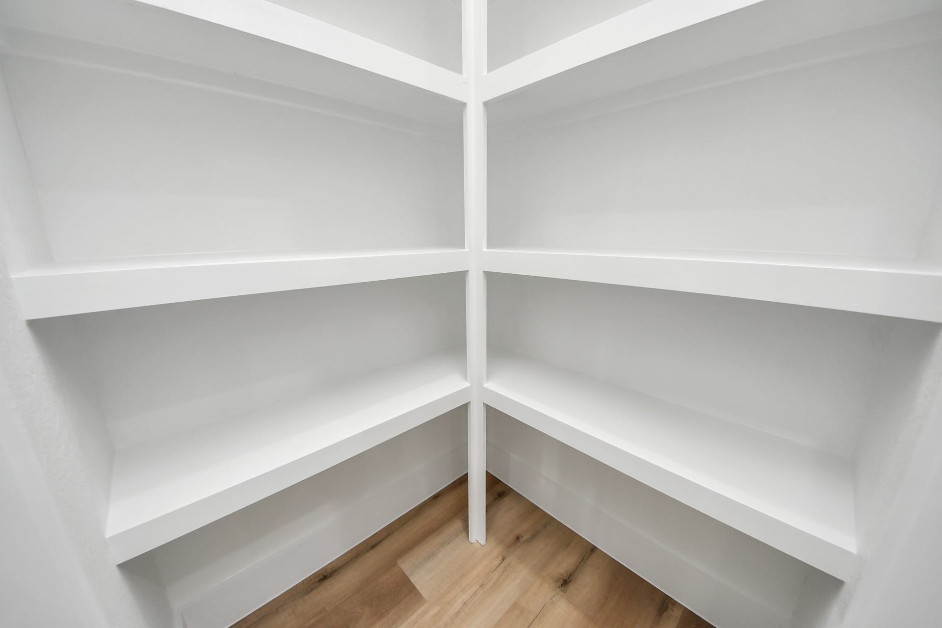 7801 King Street, Houston, TX 77028 Spacious and bright corner shelving offers ample storage with sleek white finishes, perfect for organizing your essentials.