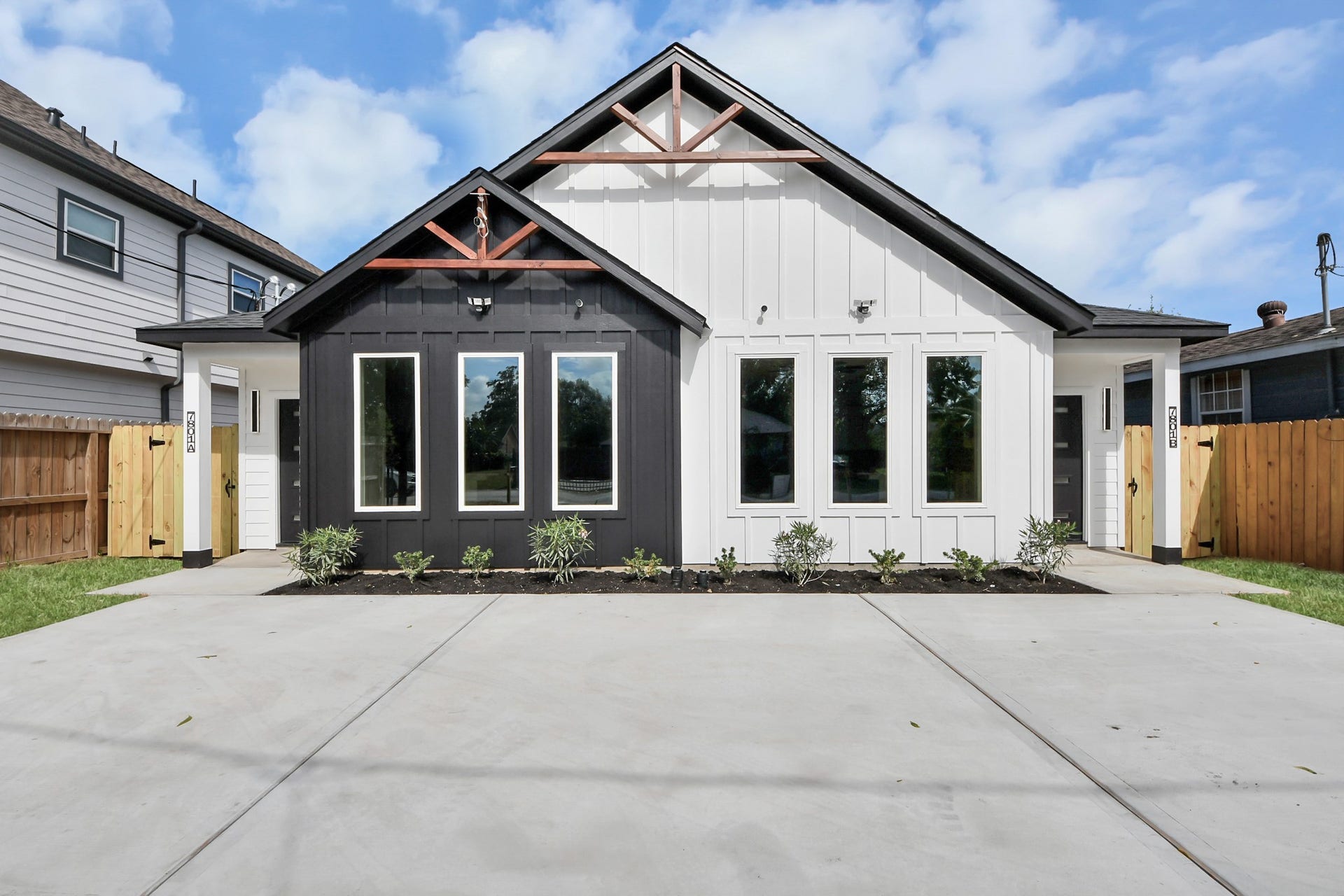 7801 King Street, Houston, TX 77028 Modern duplex with striking black and white exterior, featuring large windows and a clean, spacious driveway.