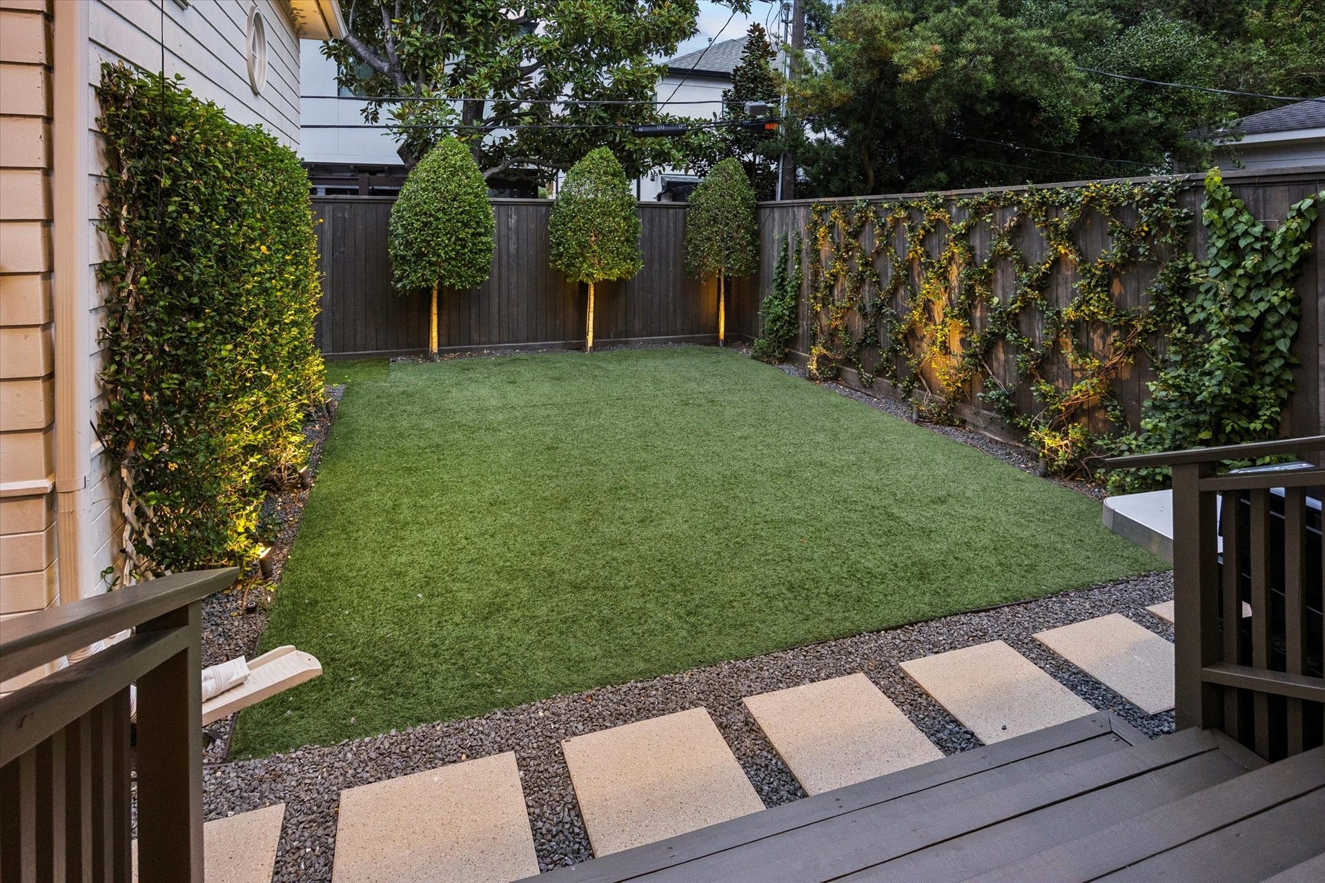 Direct access from the family room steps down to the backyard, creating an effortless connection between indoor and outdoor living.