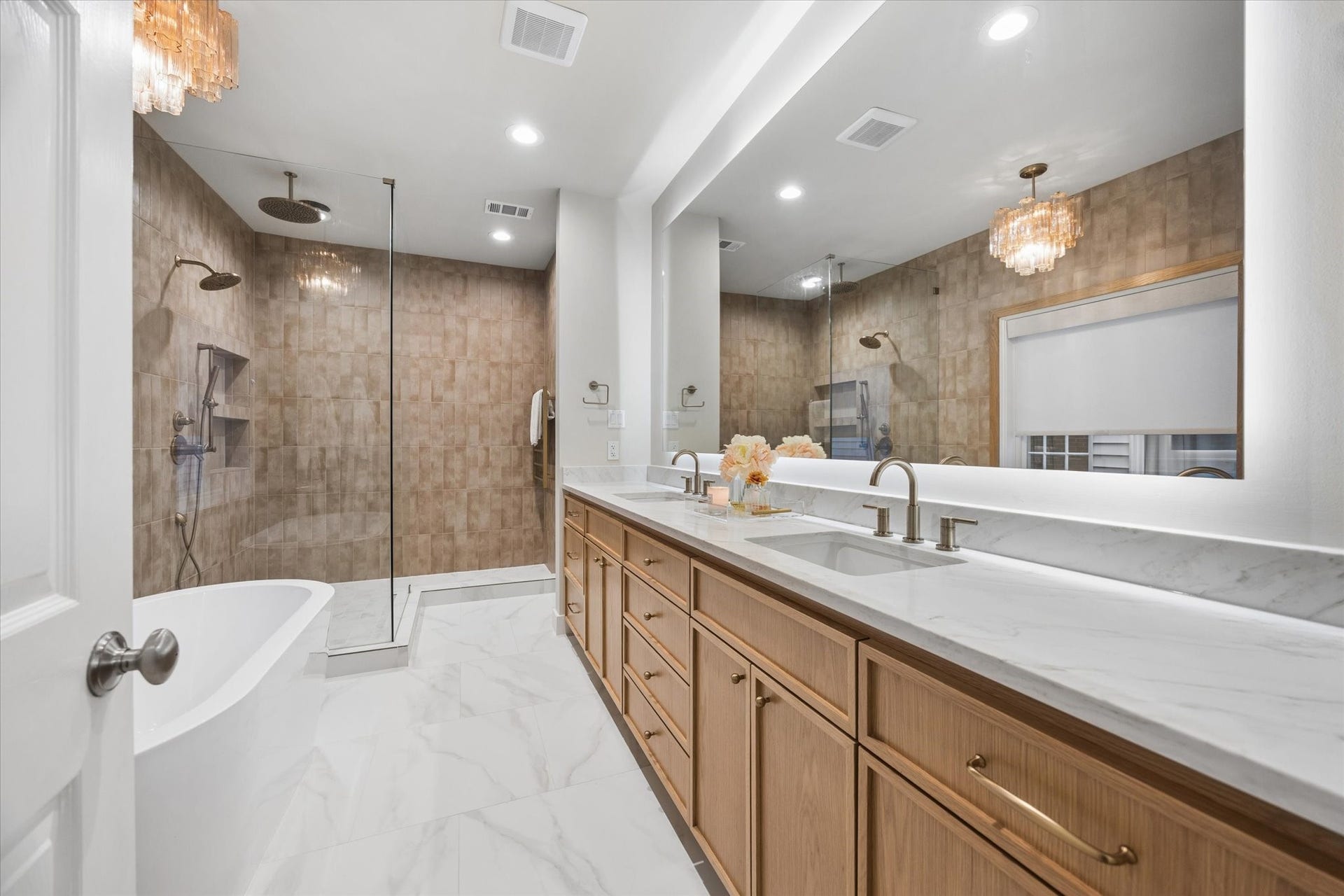 Completely remodeled primary bathroom offering a spa-like retreat with a dramatic walk-in shower, freestanding soaking tub, dual-sink vanity, designer lighting, heated towel rack, and sophisticated TOTO bidet toilet.