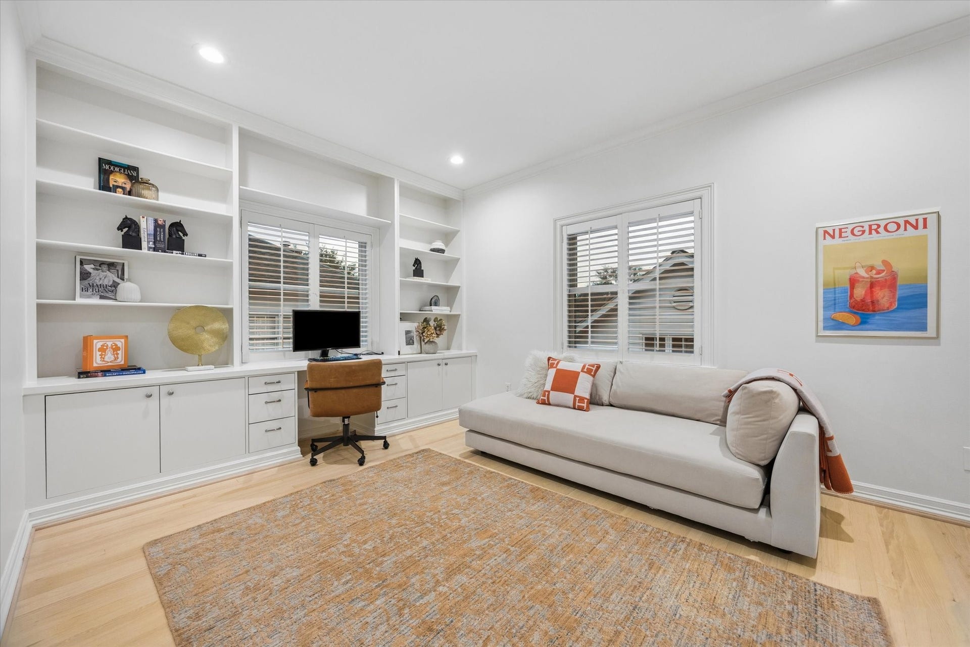 Adjoining bedroom offering wonderful flexibility as a private office, nursery or additional bedroom, featuring extensive built-in shelving and cabinetry.