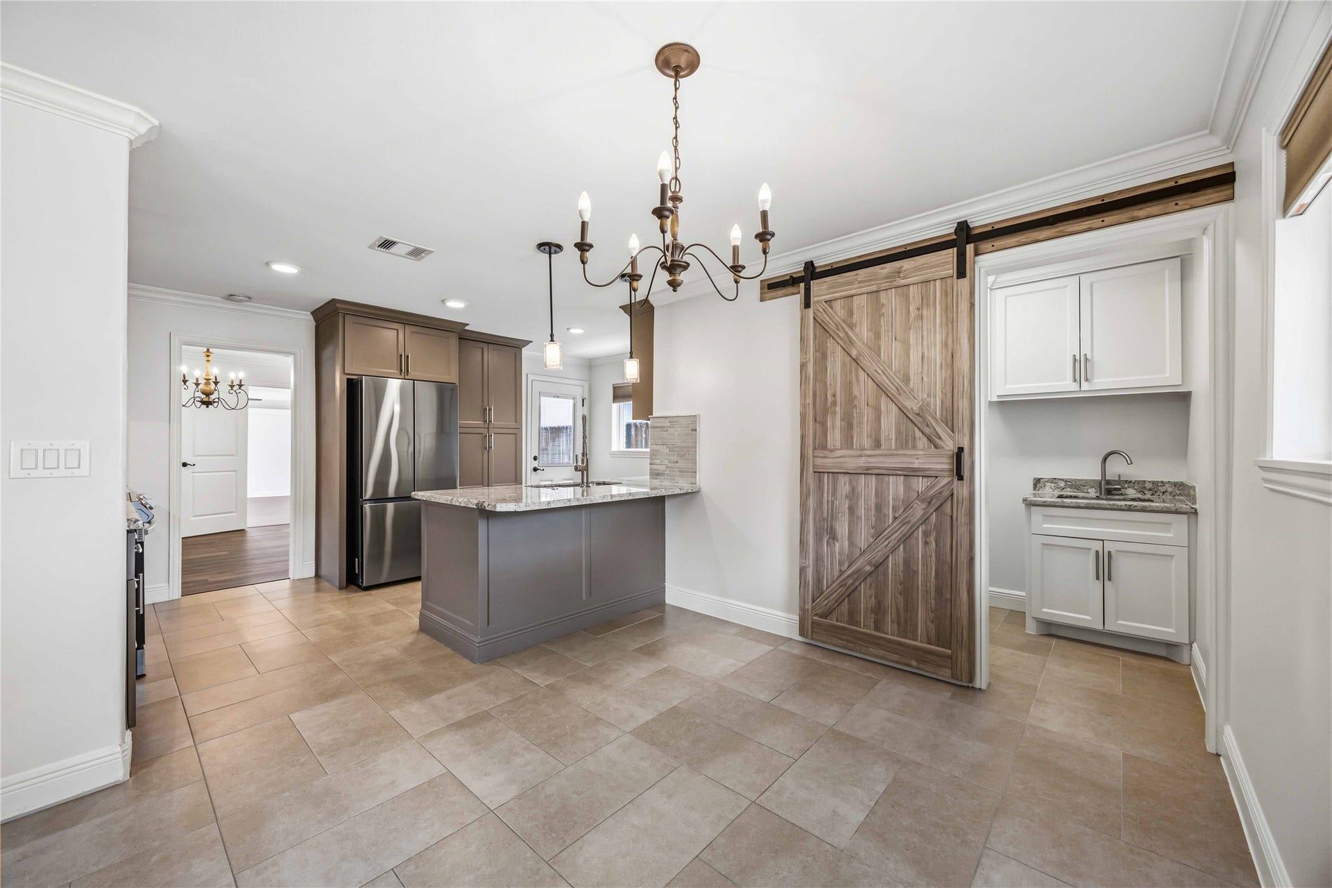 5722 N Braeswood Boulevard, Houston, TX 77096 Hidden laundry room w/ barn door off breakfast nook.