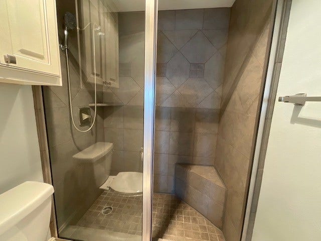Walk-in shower with seat and beautiful decorator tile
