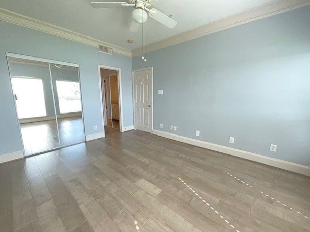 Primary bedroom looking in from window
Note the gorgeous triple crown molding and wood flooring.
