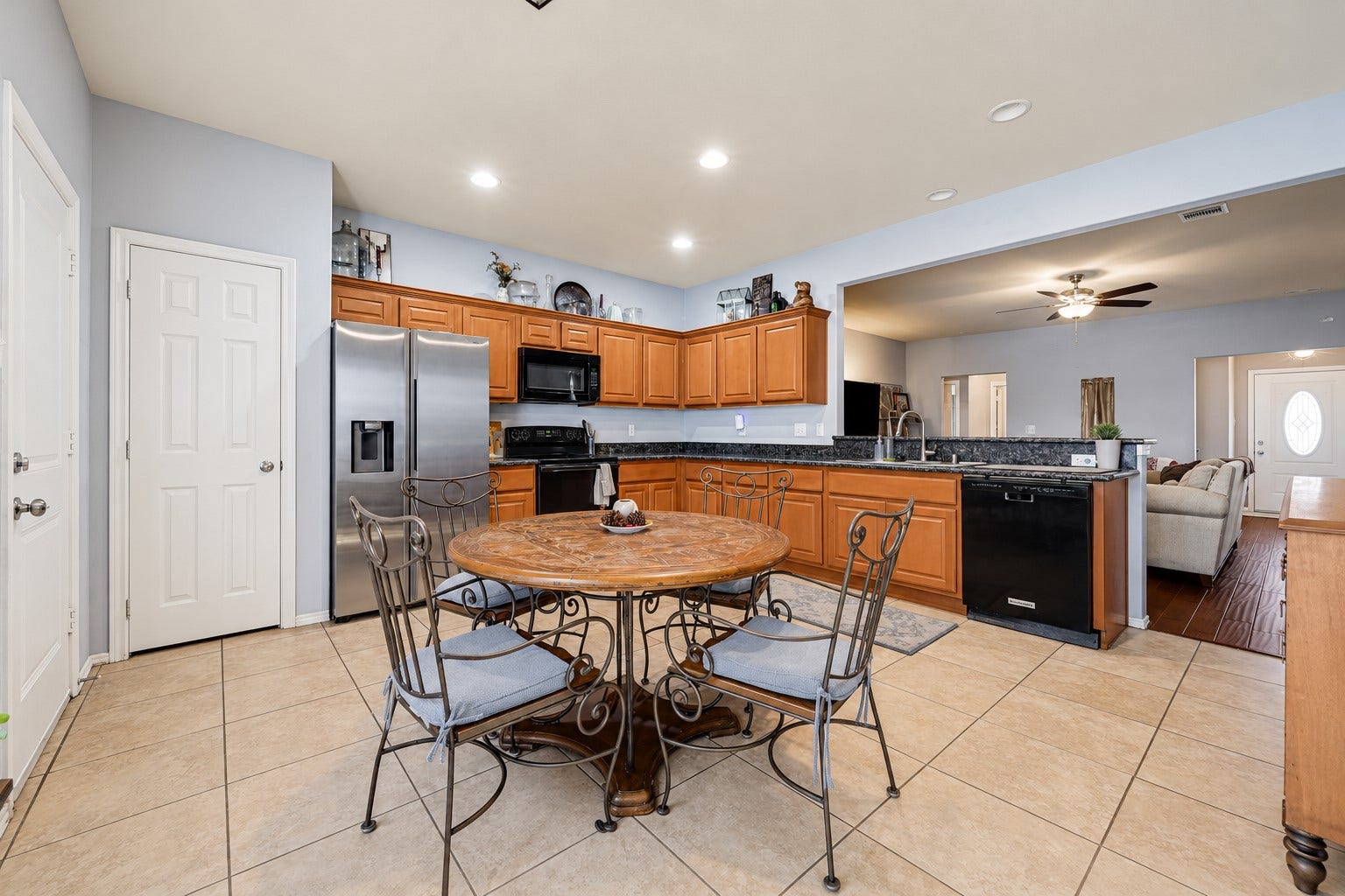 Another view of the dining area with the kitchen counters and appliances. Refrigerator, microwave, oven, and dishwasher will be sold with the house.