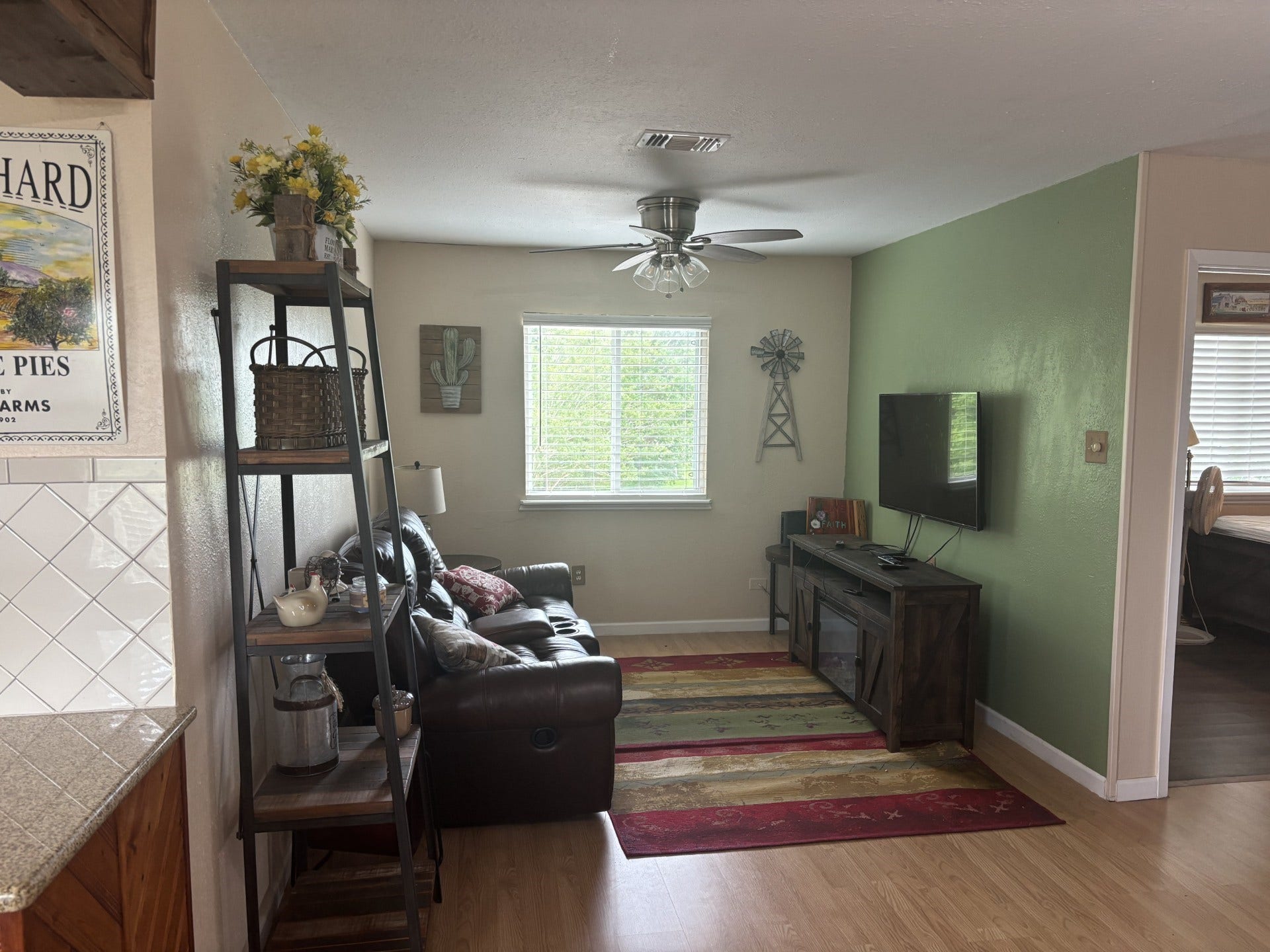 5324 Aurora Drive S, #CR378, Alvin, TX 77511 Inviting living area with a wall-mounted TV, plush seating, and stylish accent rugs.