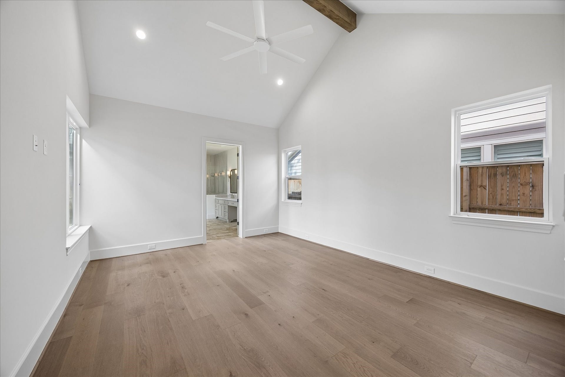 1018 Rosepoint Street, Houston, TX 77018 The first floor primary bedroom with vaulted ceilings & accent wood beam.