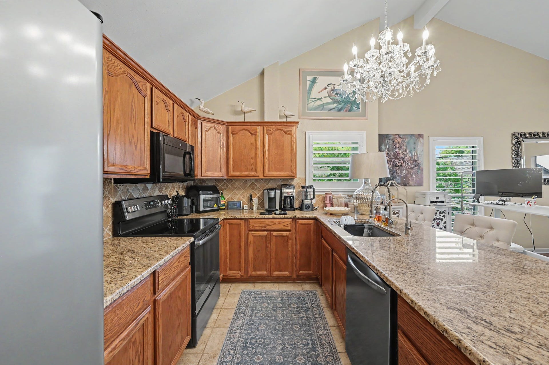 Enjoy a spacious, open-concept living area featuring a generous living room that flows seamlessly into a full-sized dining space. The kitchen offers a convenient breakfast bar and pantry for added storage. A sliding glass door leads to the covered patio, where you can relax and take in beautiful views of Lake Conroe!