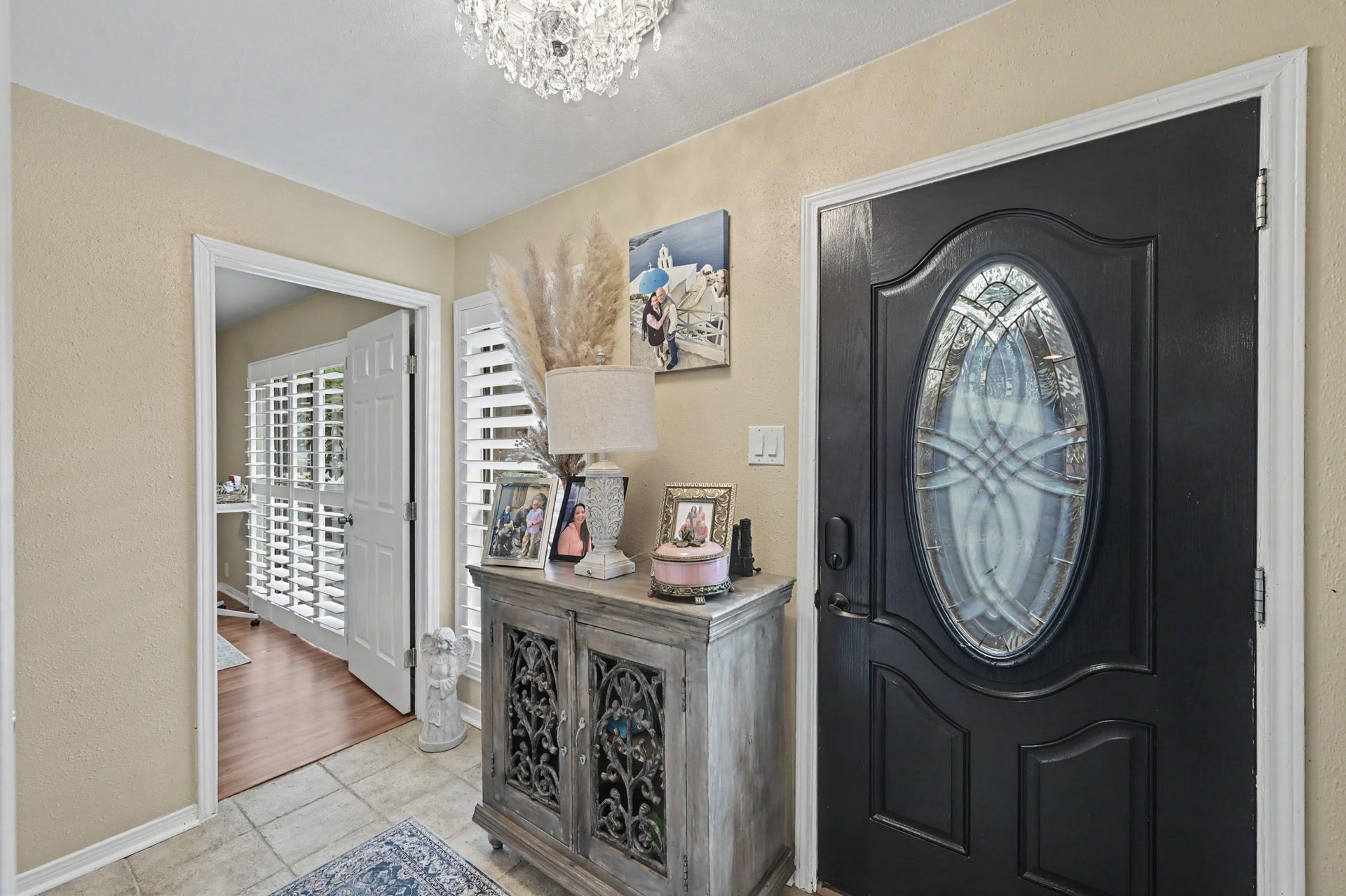 A view of the front door and into the primary from the downstairs hallway.