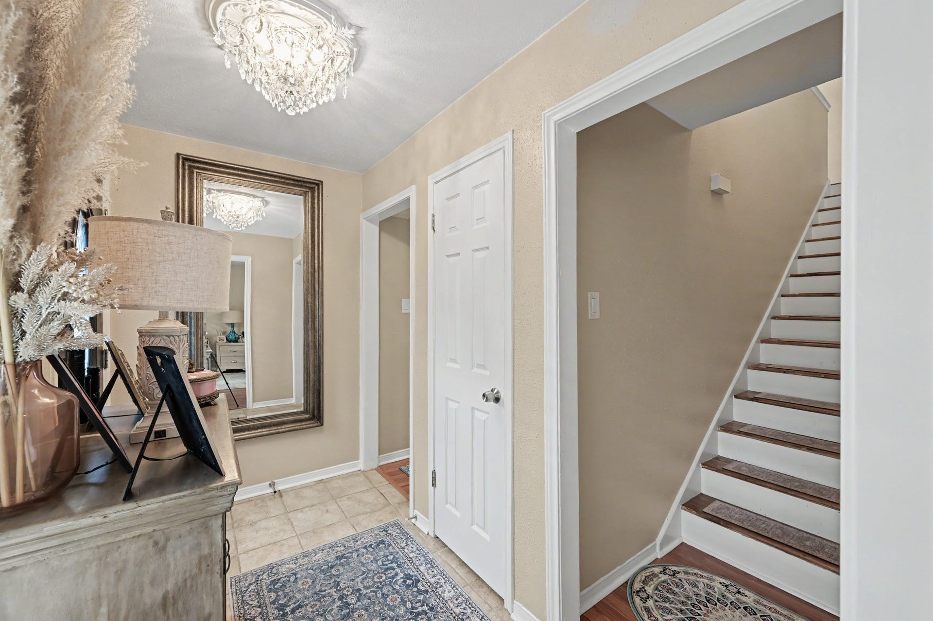Upon entering the front door, youll find the stairs and primary bedroom to your right, with two additional bedrooms, a convenient laundry closet, and a full bathroom located straight ahead.