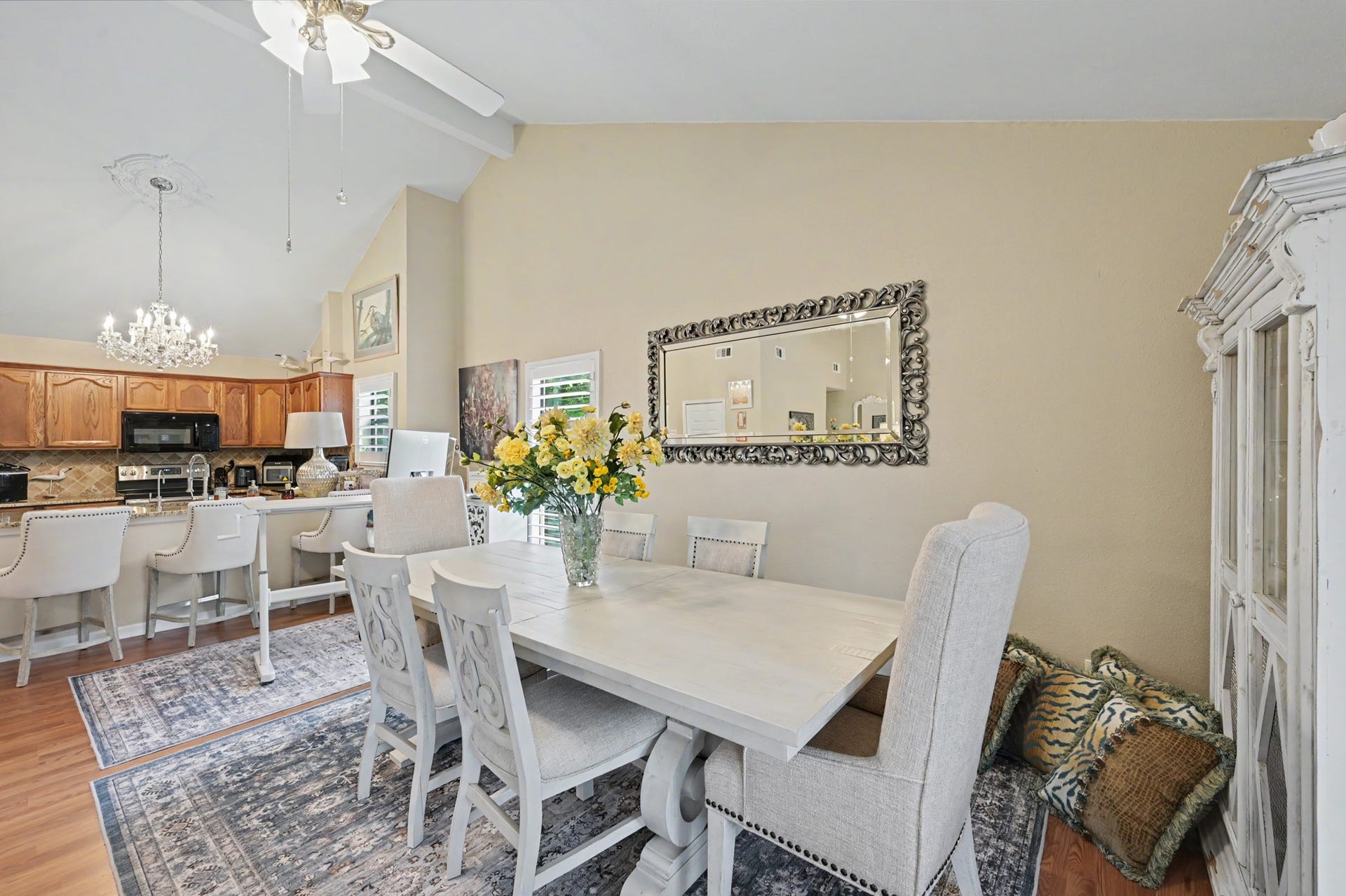 Enjoy a spacious, open-concept living area featuring a generous living room that flows seamlessly into a full-sized dining space. The kitchen offers a convenient breakfast bar and pantry for added storage. A sliding glass door leads to the covered patio, where you can relax and take in beautiful views of Lake Conroe!