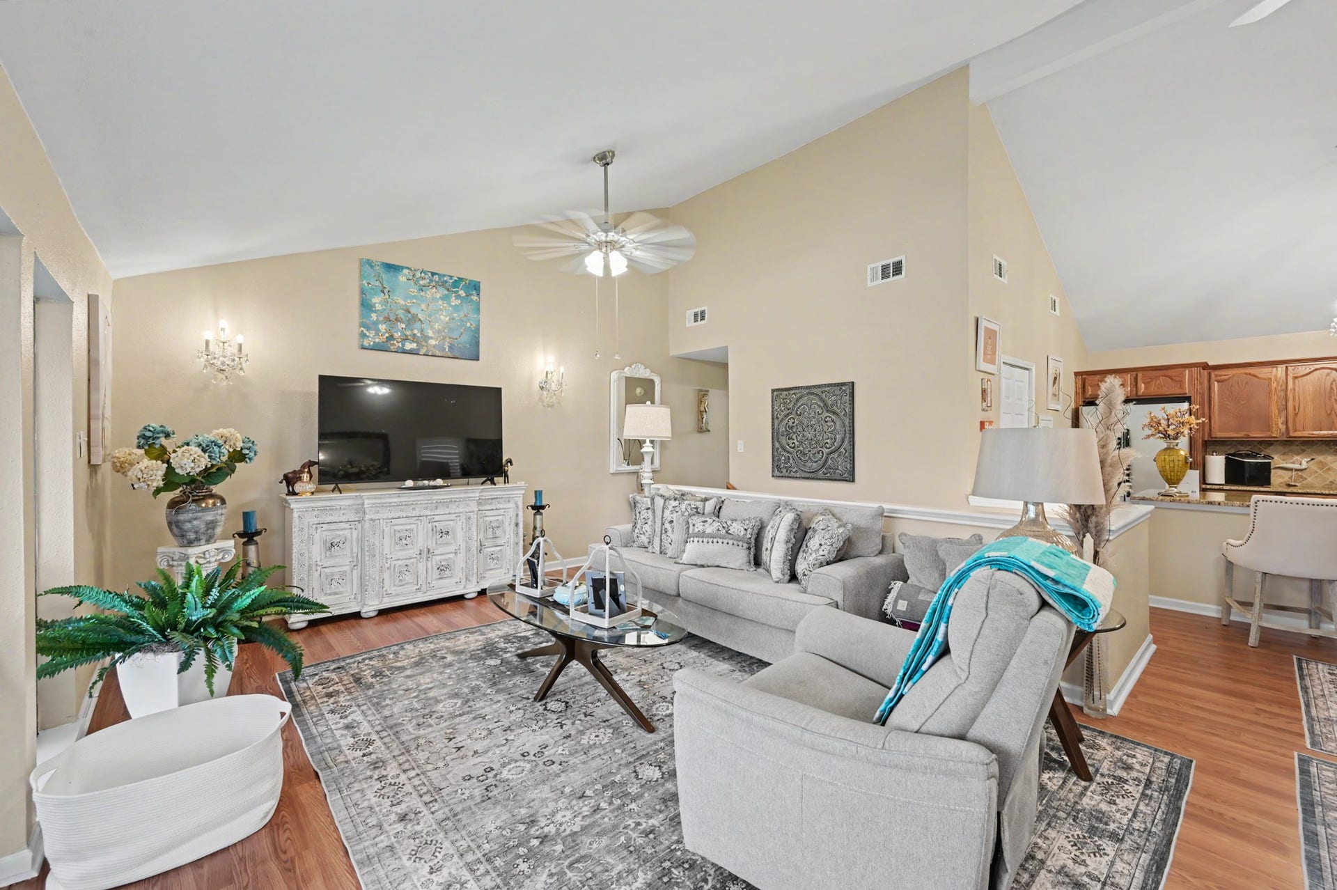 Enjoy a spacious, open-concept living area featuring a generous living room that flows seamlessly into a full-sized dining space. The kitchen offers a convenient breakfast bar and pantry for added storage. A sliding glass door leads to the covered patio, where you can relax and take in beautiful views of Lake Conroe!