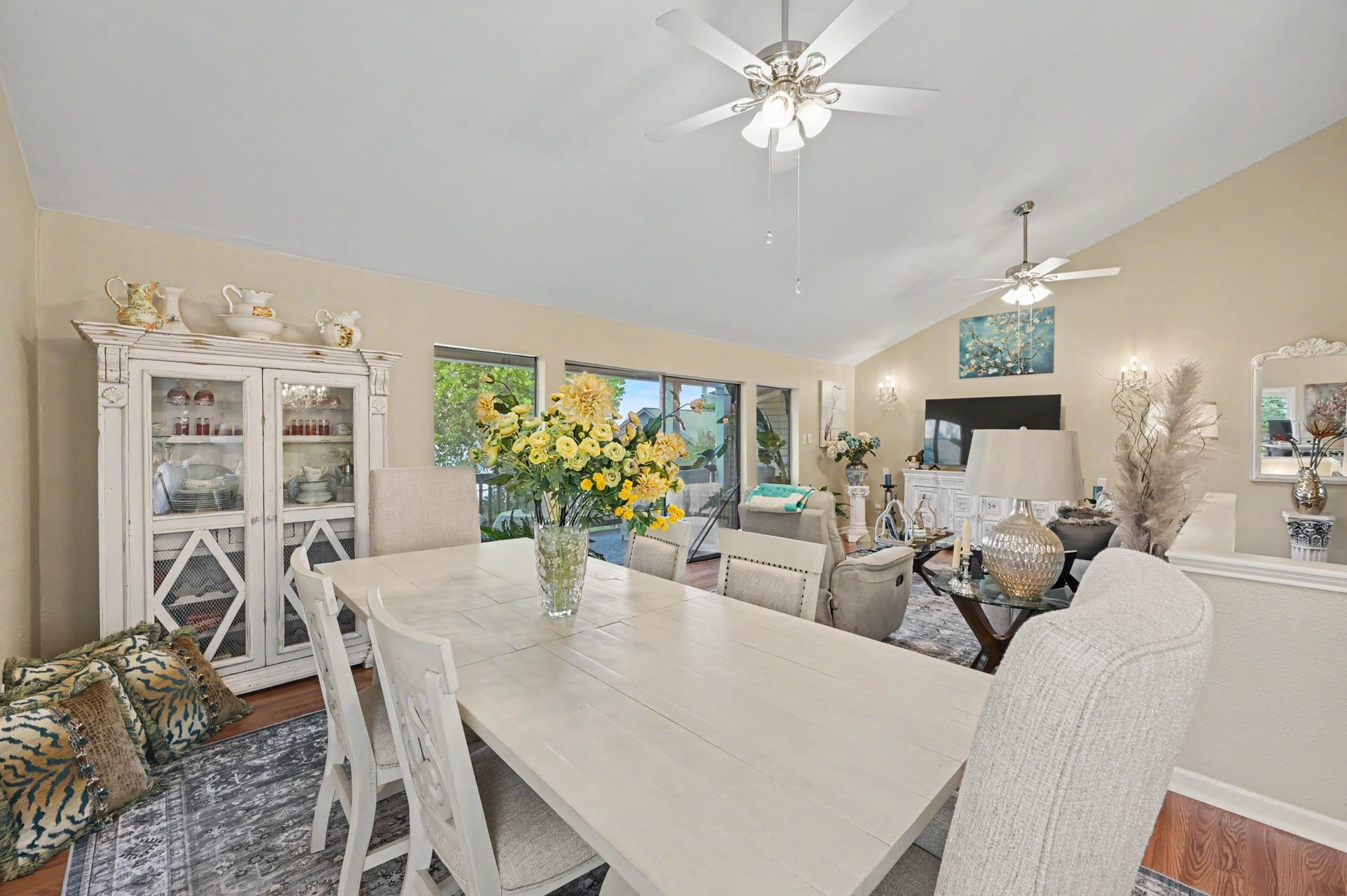 Enjoy a spacious, open-concept living area featuring a generous living room that flows seamlessly into a full-sized dining space. The kitchen offers a convenient breakfast bar and pantry for added storage. A sliding glass door leads to the covered patio, where you can relax and take in beautiful views of Lake Conroe!