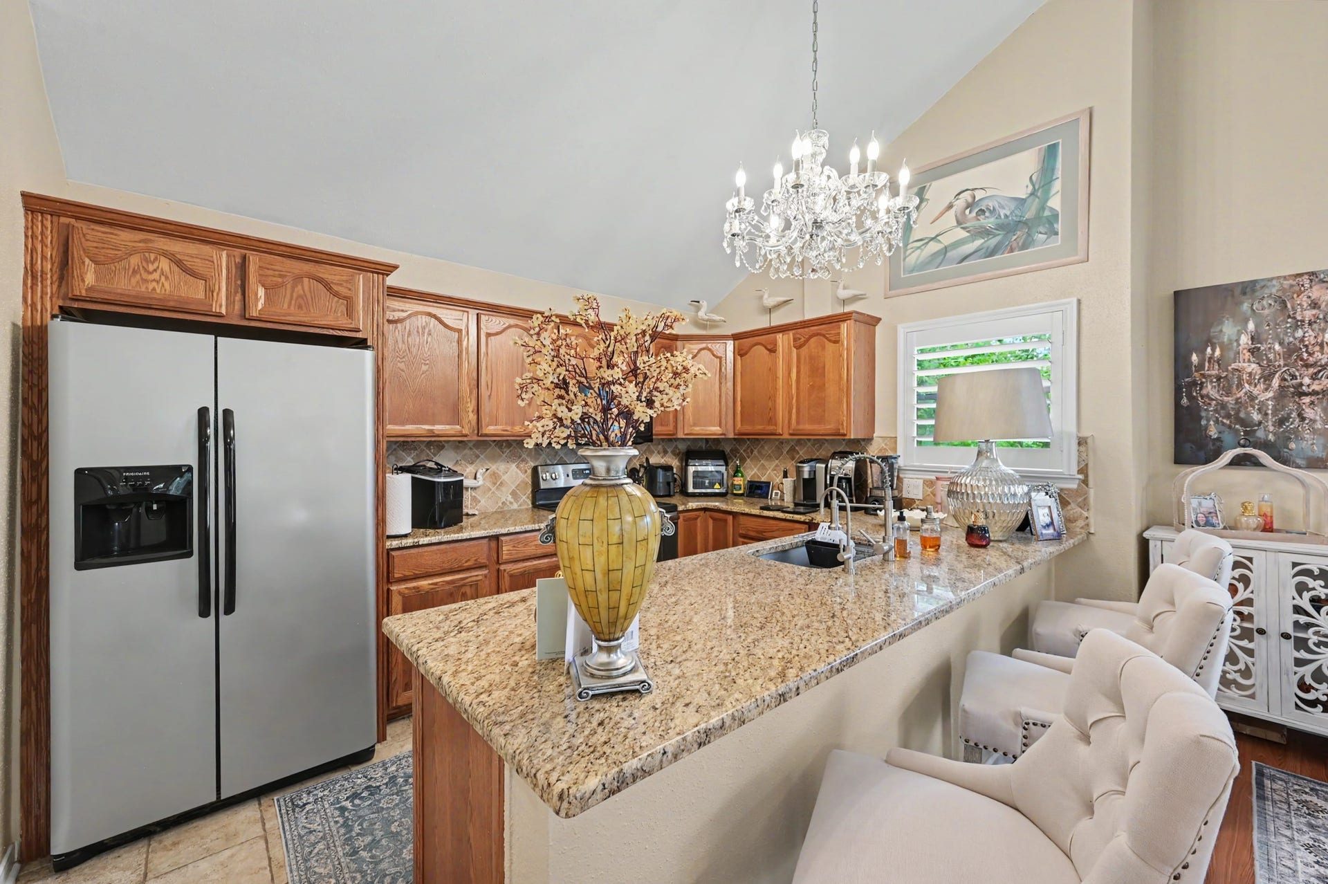 Enjoy a spacious, open-concept living area featuring a generous living room that flows seamlessly into a full-sized dining space. The kitchen offers a convenient breakfast bar and pantry for added storage. A sliding glass door leads to the covered patio, where you can relax and take in beautiful views of Lake Conroe!