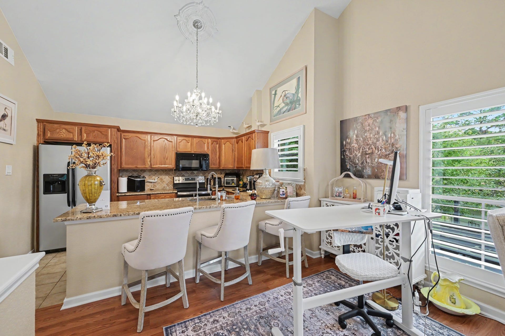 Enjoy a spacious, open-concept living area featuring a generous living room that flows seamlessly into a full-sized dining space. The kitchen offers a convenient breakfast bar and pantry for added storage. A sliding glass door leads to the covered patio, where you can relax and take in beautiful views of Lake Conroe!