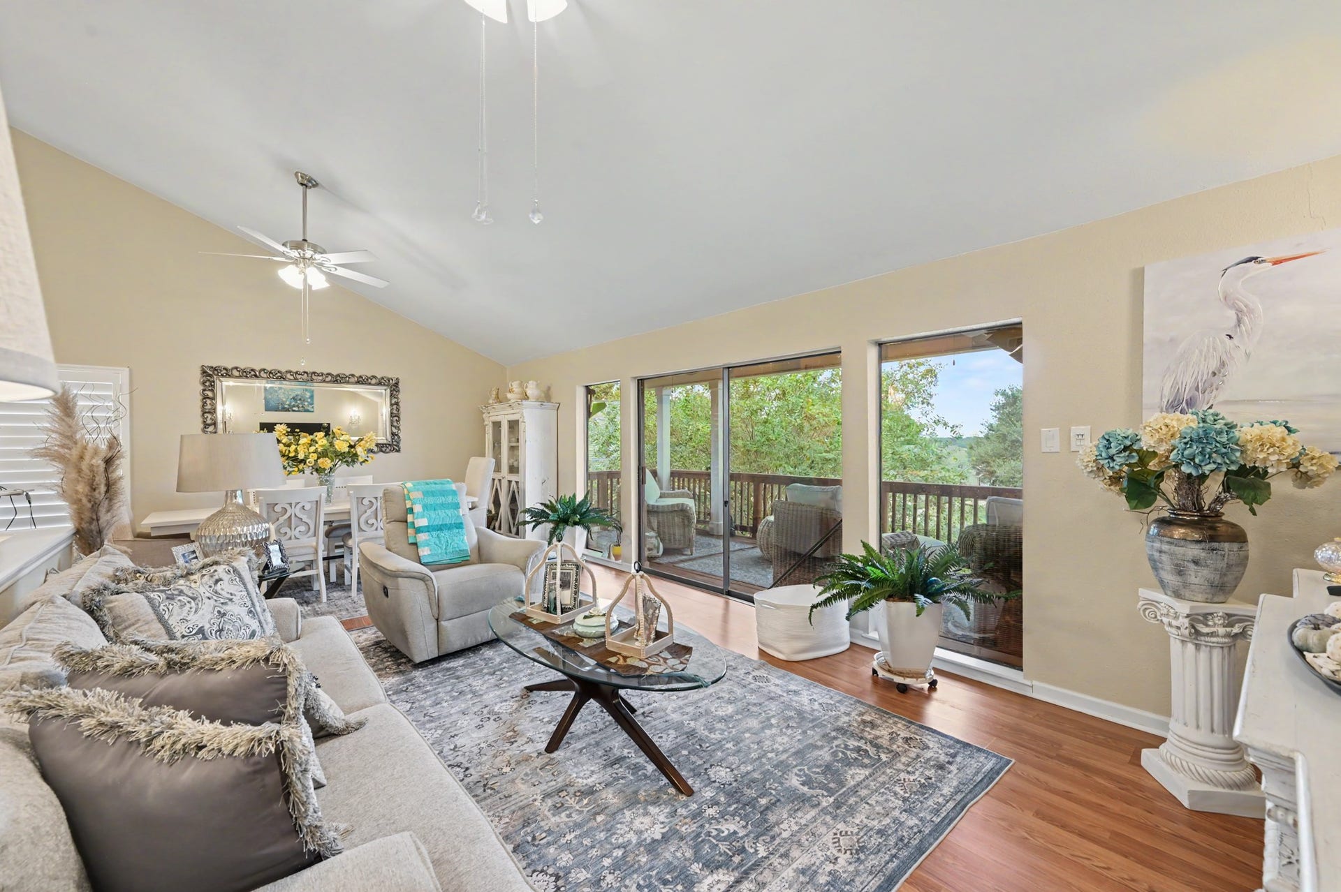 Enjoy a spacious, open-concept living area featuring a generous living room that flows seamlessly into a full-sized dining space. The kitchen offers a convenient breakfast bar and pantry for added storage. A sliding glass door leads to the covered patio, where you can relax and take in beautiful views of Lake Conroe!