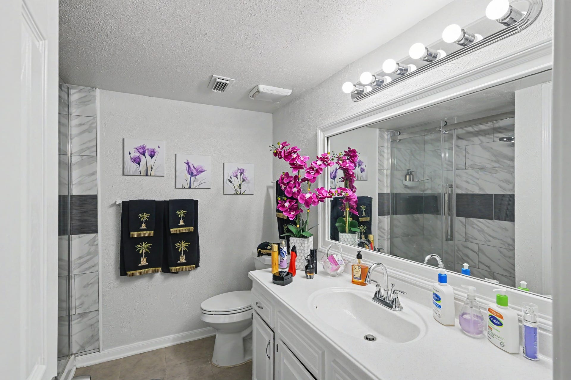 The primary en-suite bathroom offers convenience, style and privacy, located just steps from the bedroom.