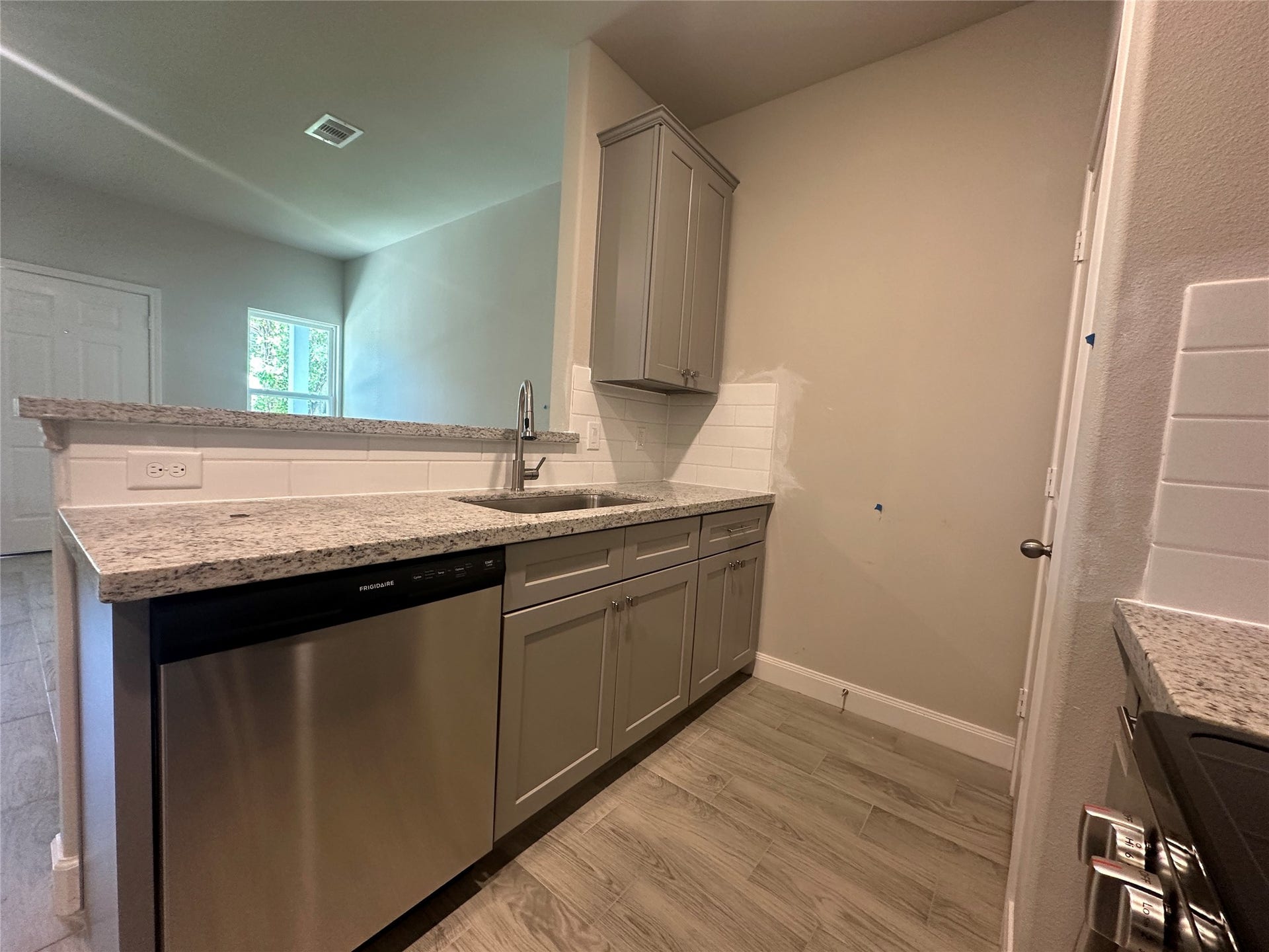 104 Turner Drive, Willis, TX 77378 Bright and functional kitchen workspace showcasing premium granite and clean finishes.