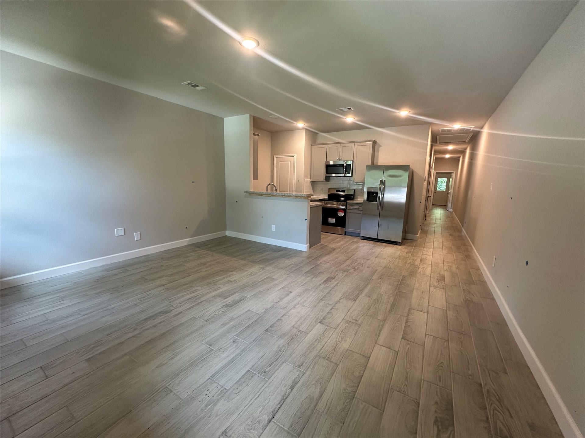 104 Turner Drive, Willis, TX 77378 Unit A; large open-concept layout with premium tile flooring.